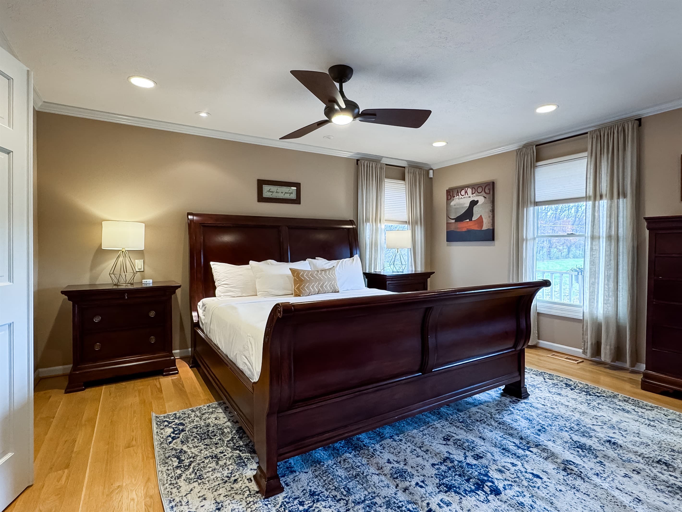 Main level spacious primary bedroom is a King Bed en suite with crisp white linens and a plush bed at Pointer Haus