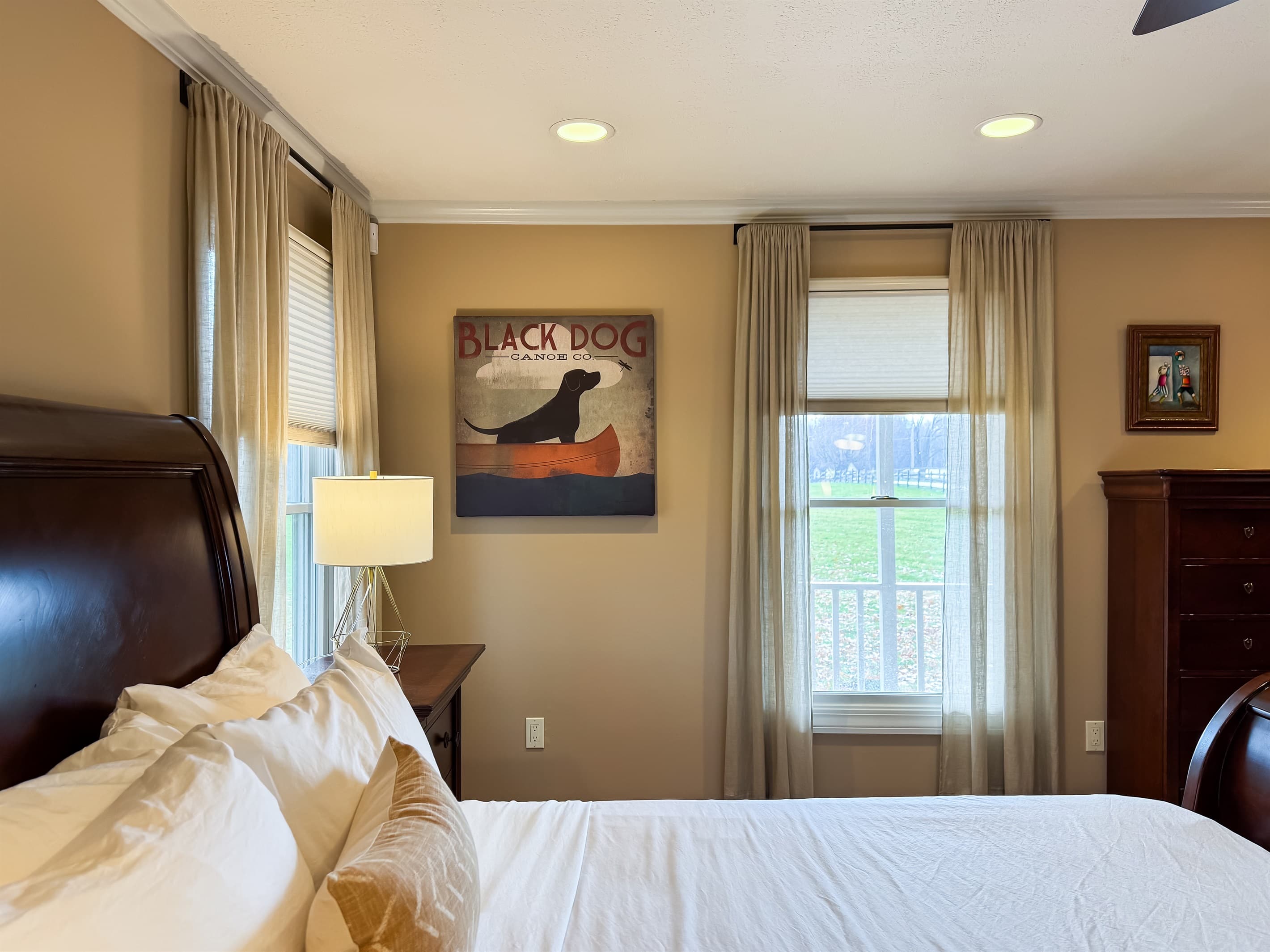 Main level warm and inviting plush King Bedroom with views of the private yard at Pointer Haus.