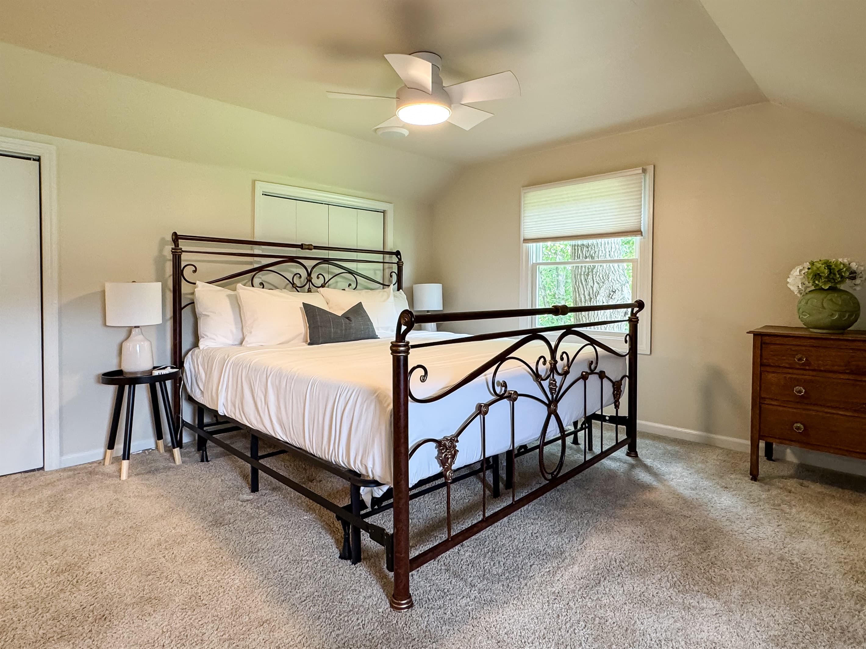 Spacious bedroom 5 with King bed on upper level with crisp white linens and a Jack and Jill bathroom that has a tub/shower combo that includes fluffy white towels, shampoo/conditioner with mini bar of handmade goat milk soap at Pointer Haus.
