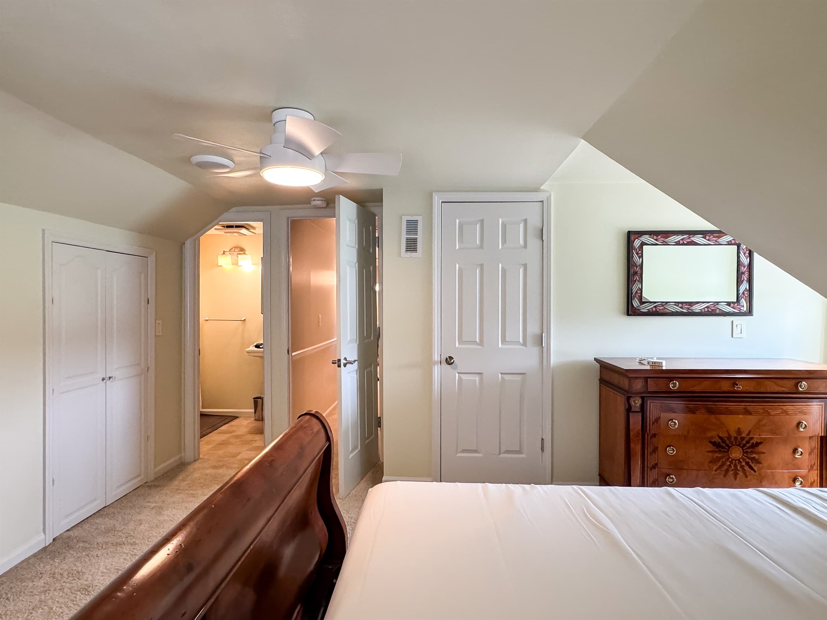 Spacious and plush king size bedroom 3 (upper level) with crisp white linens and en suite bathroom at Pointer Haus.