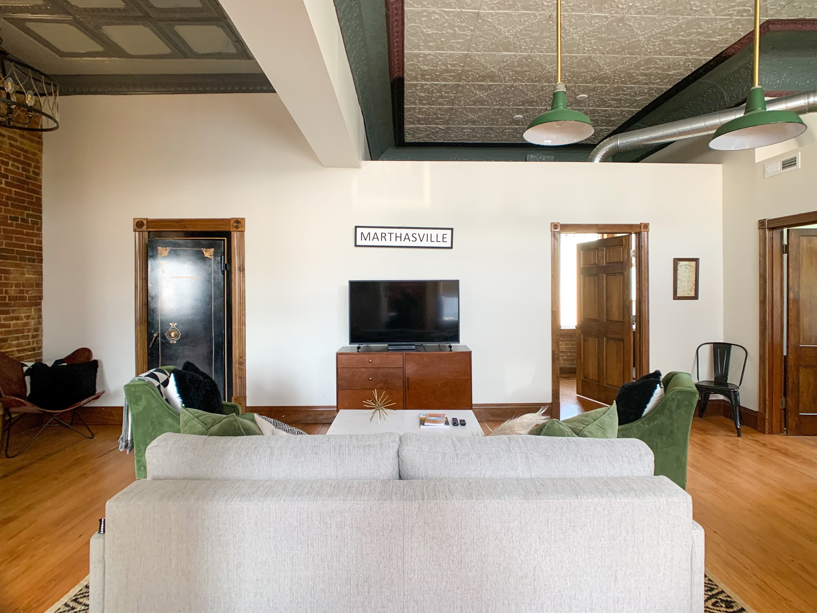 Main level spacious living area with entrance to two bathrooms. The original bank vault still in use but now as the laundry room with washer and dryer at the Bank Haus.