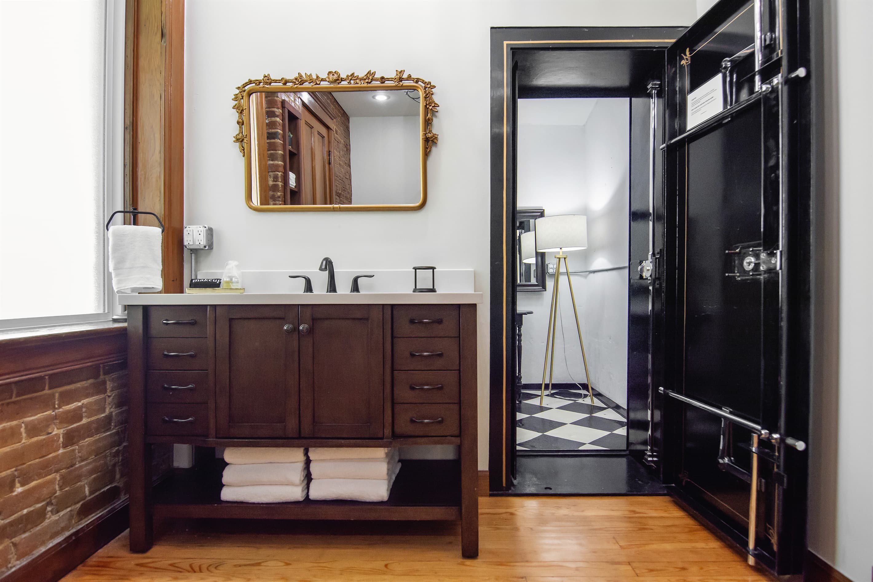 Spacious full bathroom with original bank vault turned dressing room.