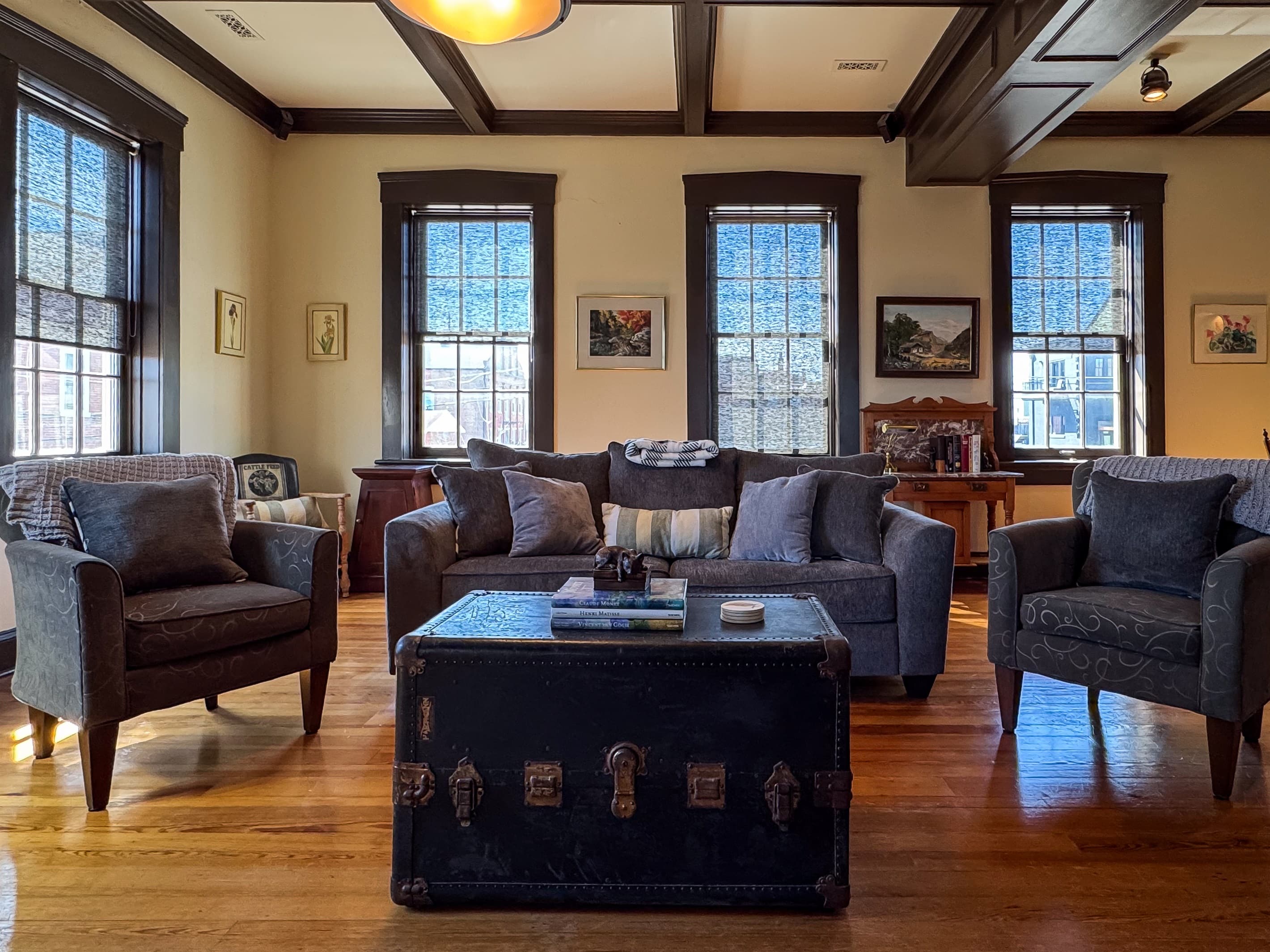 Spacious living room with huge windows and tall ceilings and abundant seating that includes a sleeper sofa in downtown Washington, MO at Tamm Loft.