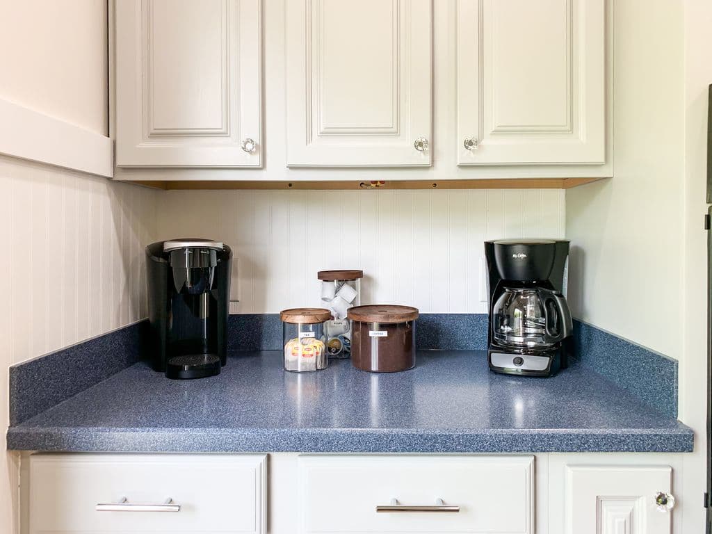 Coffee station with Keurig, traditional coffee pot, and coffee cups.