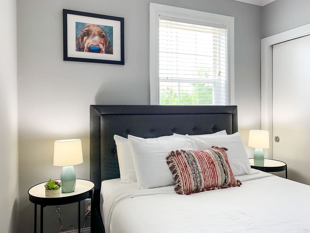 Main level bedroom 1 with queen bed, full closet and smart TV.