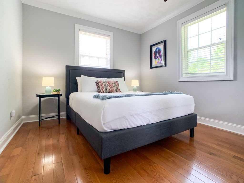 Main level bedroom 2 with queen bed, and full size closet with mirrors.