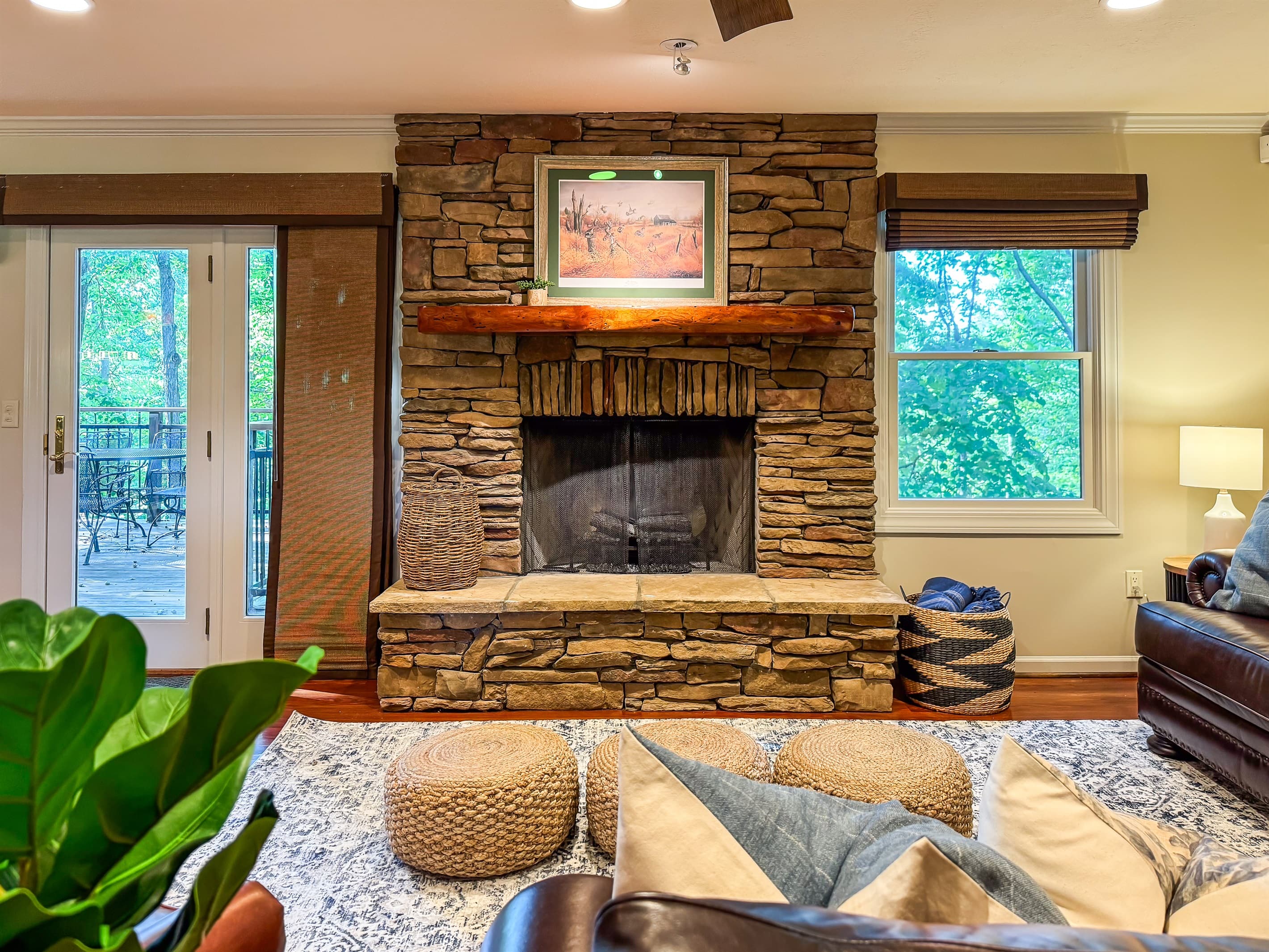 The rustic stone fireplace and wood mantel adds to the cabin like atmosphere in the Living Room at Pointer Haus.