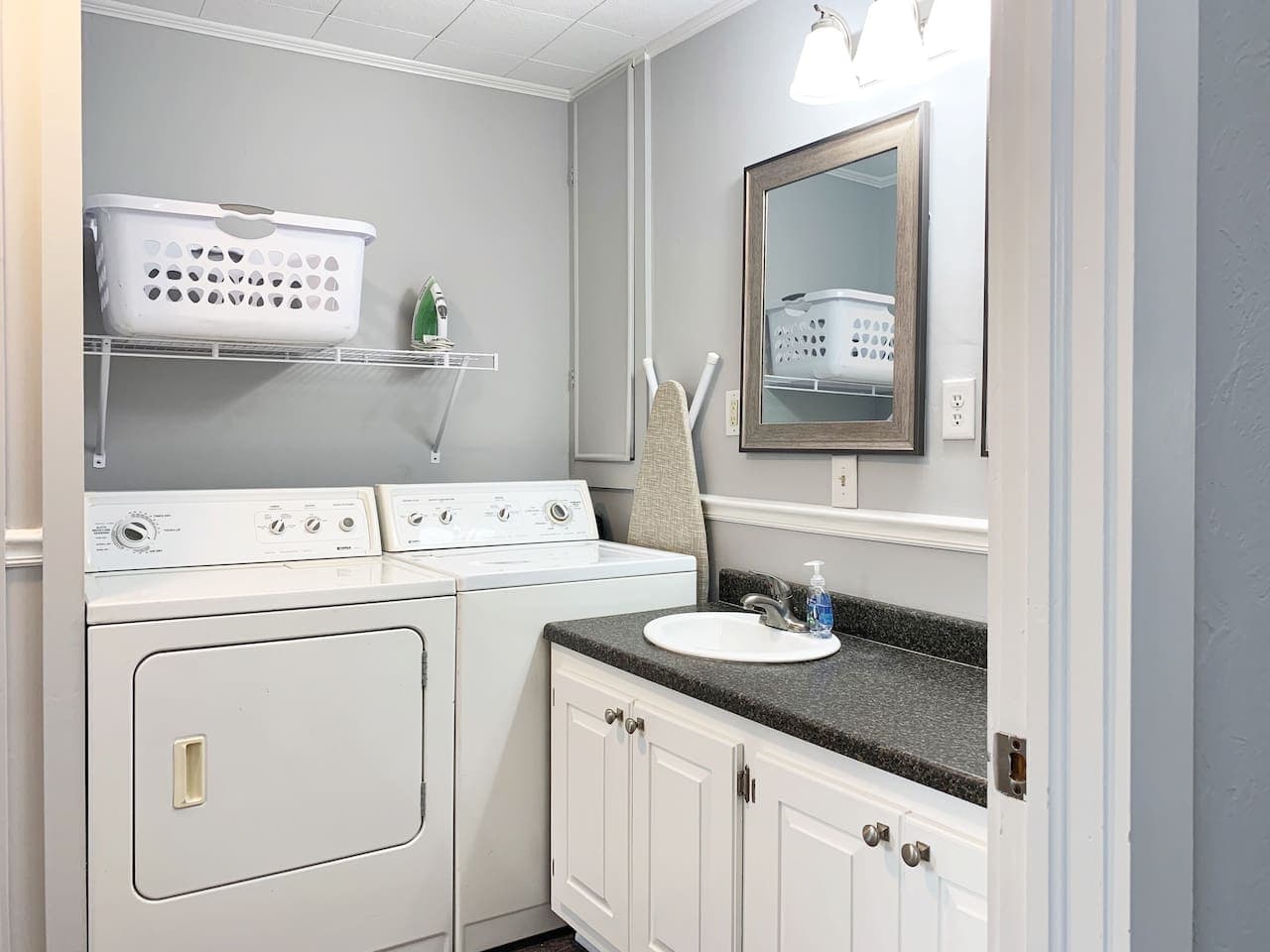 Spacious bathroom with full sized washer/dryer combo and ample vanity counter space at the Fox Haus.