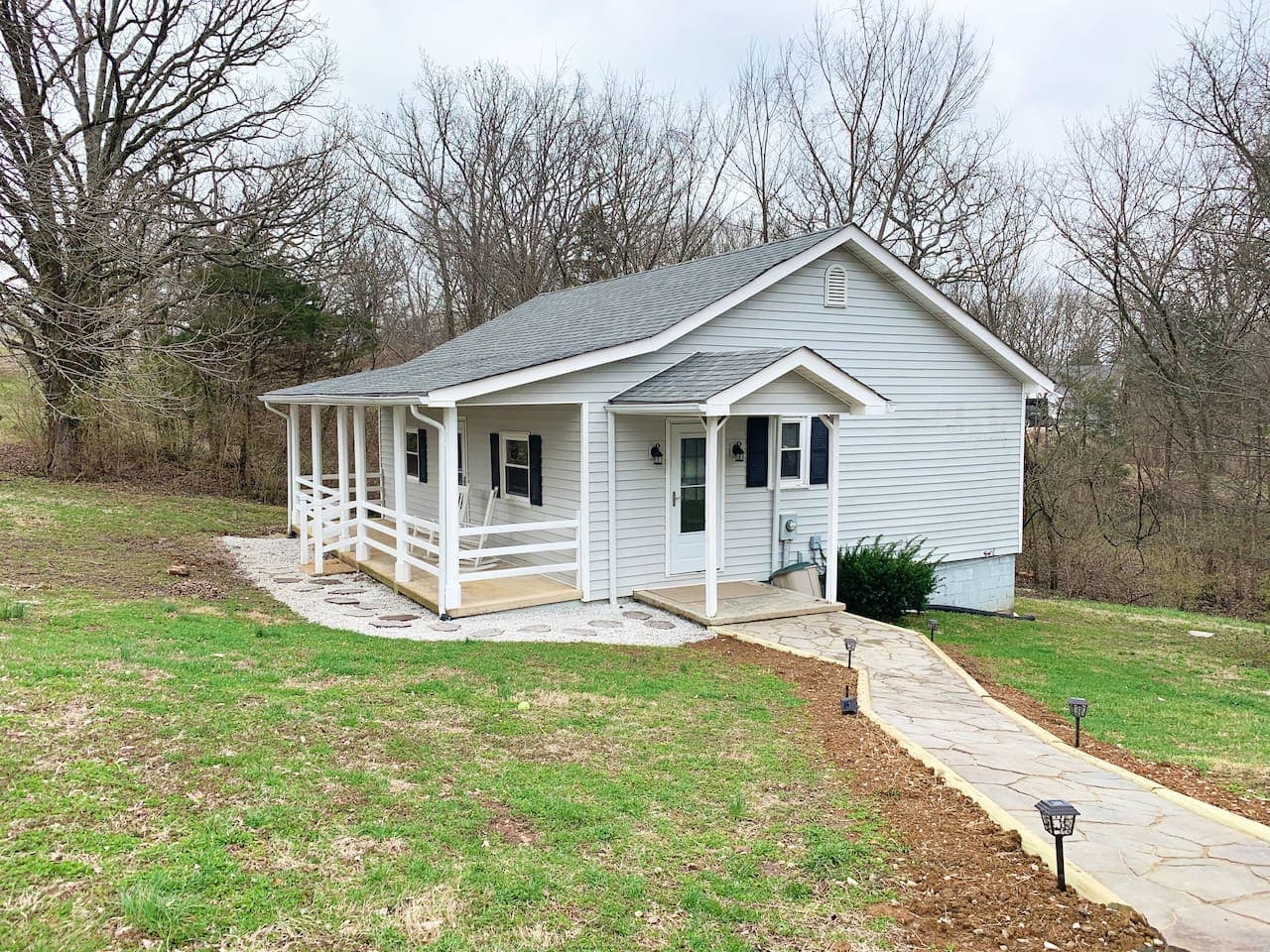Large outdoor space for doggies and a front porch with seating area.