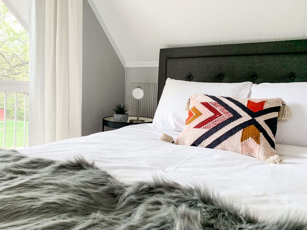 Bright and inviting upper level bedroom with a cozy queen bed.
