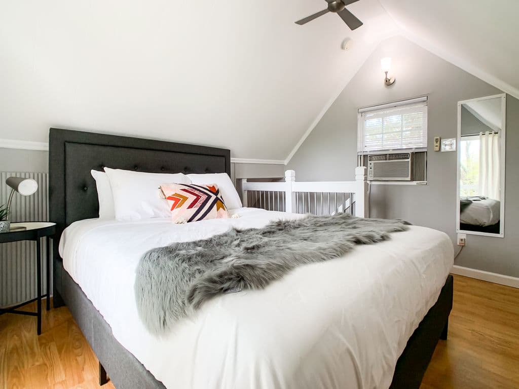 Bright and inviting upper level bedroom with a cozy queen bed at the Hound Haus.