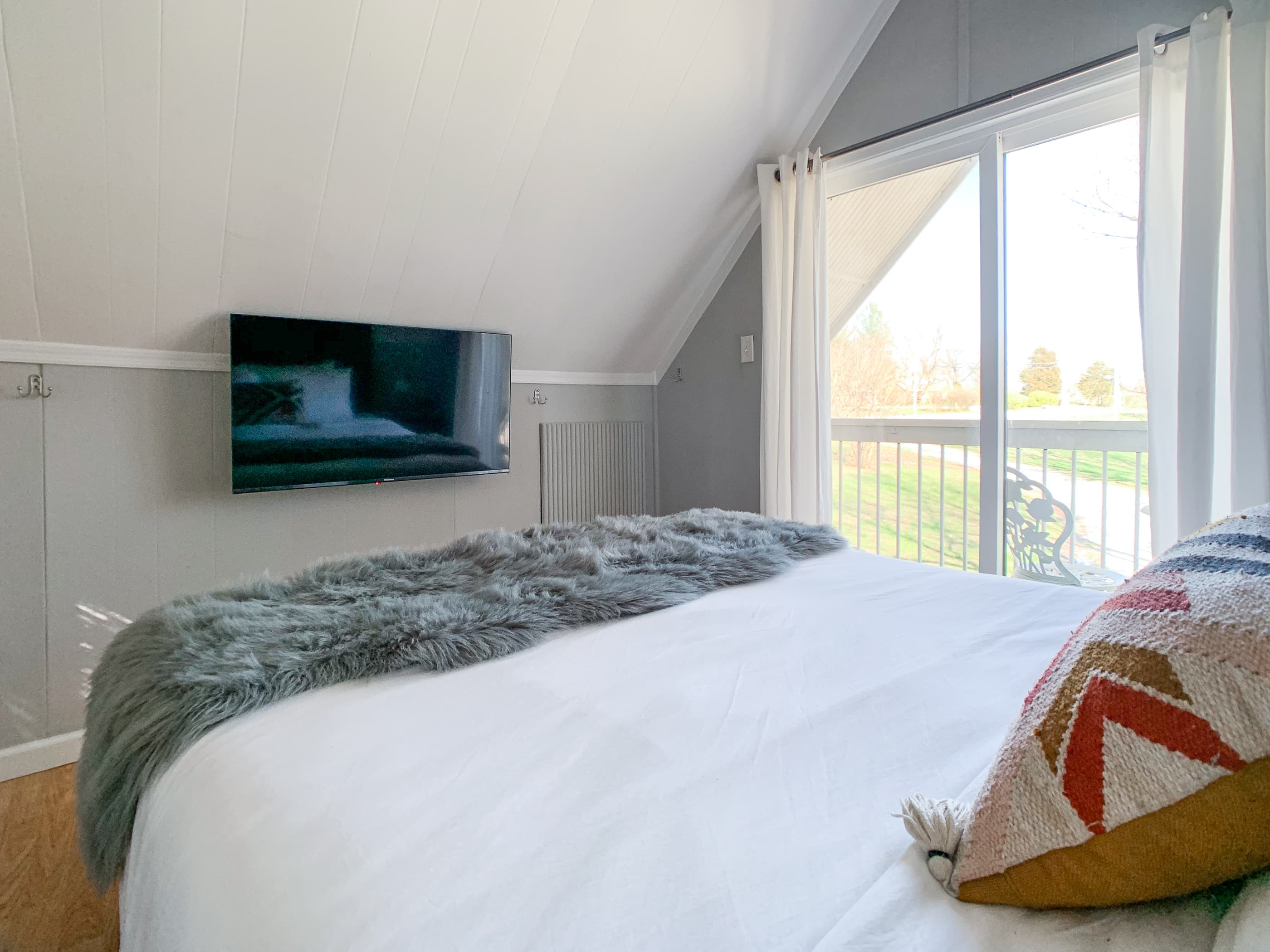 Smart tv and balcony access from loft bedroom at the Hound Haus.