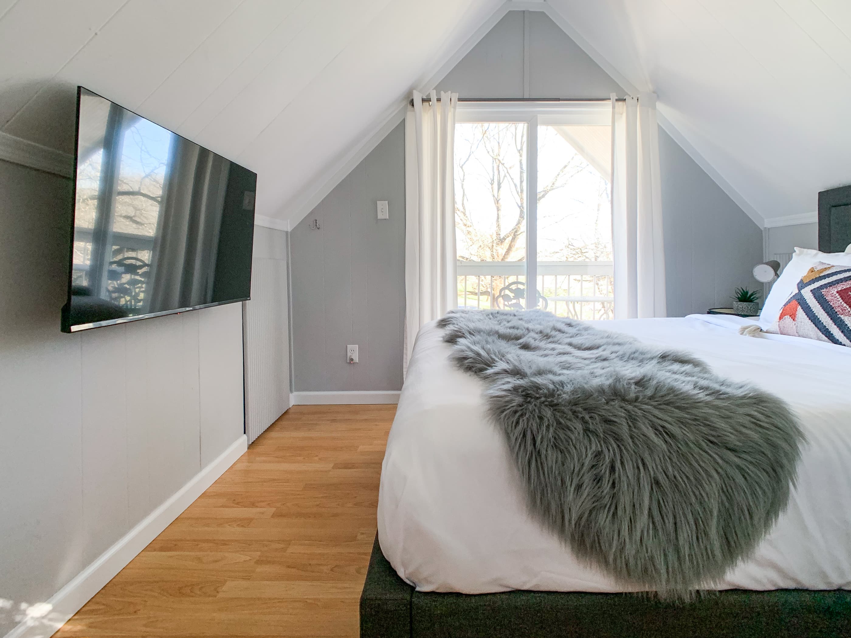 Loft queen bedroom with balcony access at the Hound Haus.