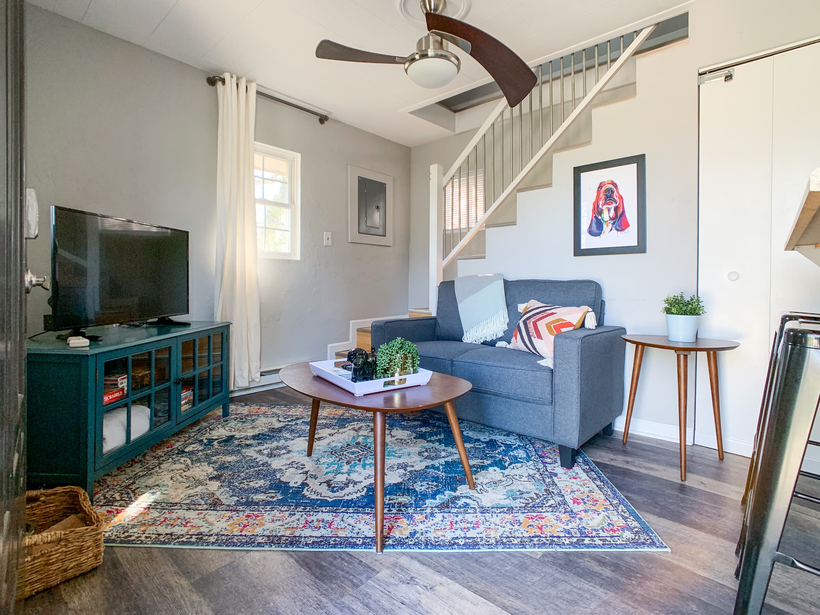 Living area with love seat couch, smart TV, and board games