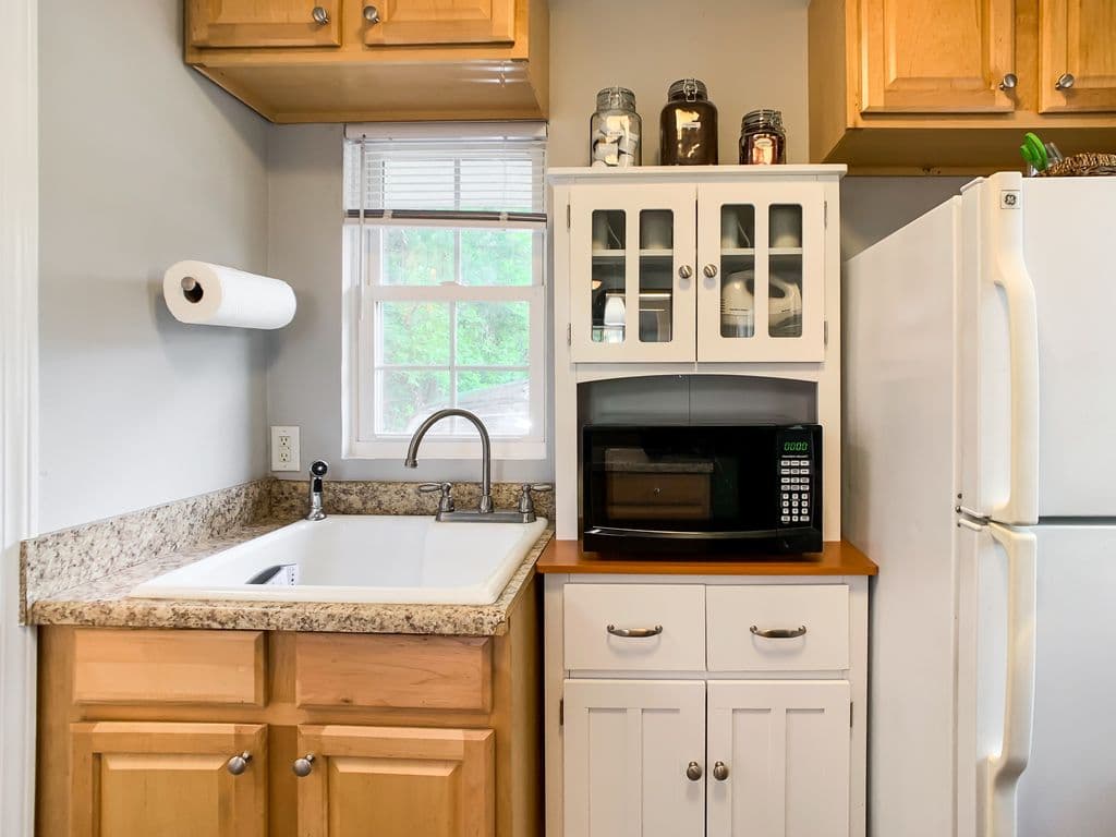 Fridge, microwave, sink - window AC above the sink in the summer.