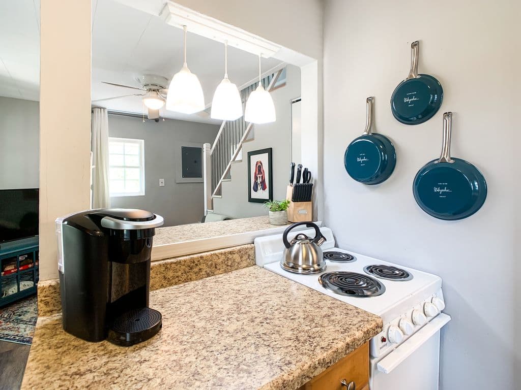 Breakfast bar, small counter space, and 4 burner stove for at home cooking.