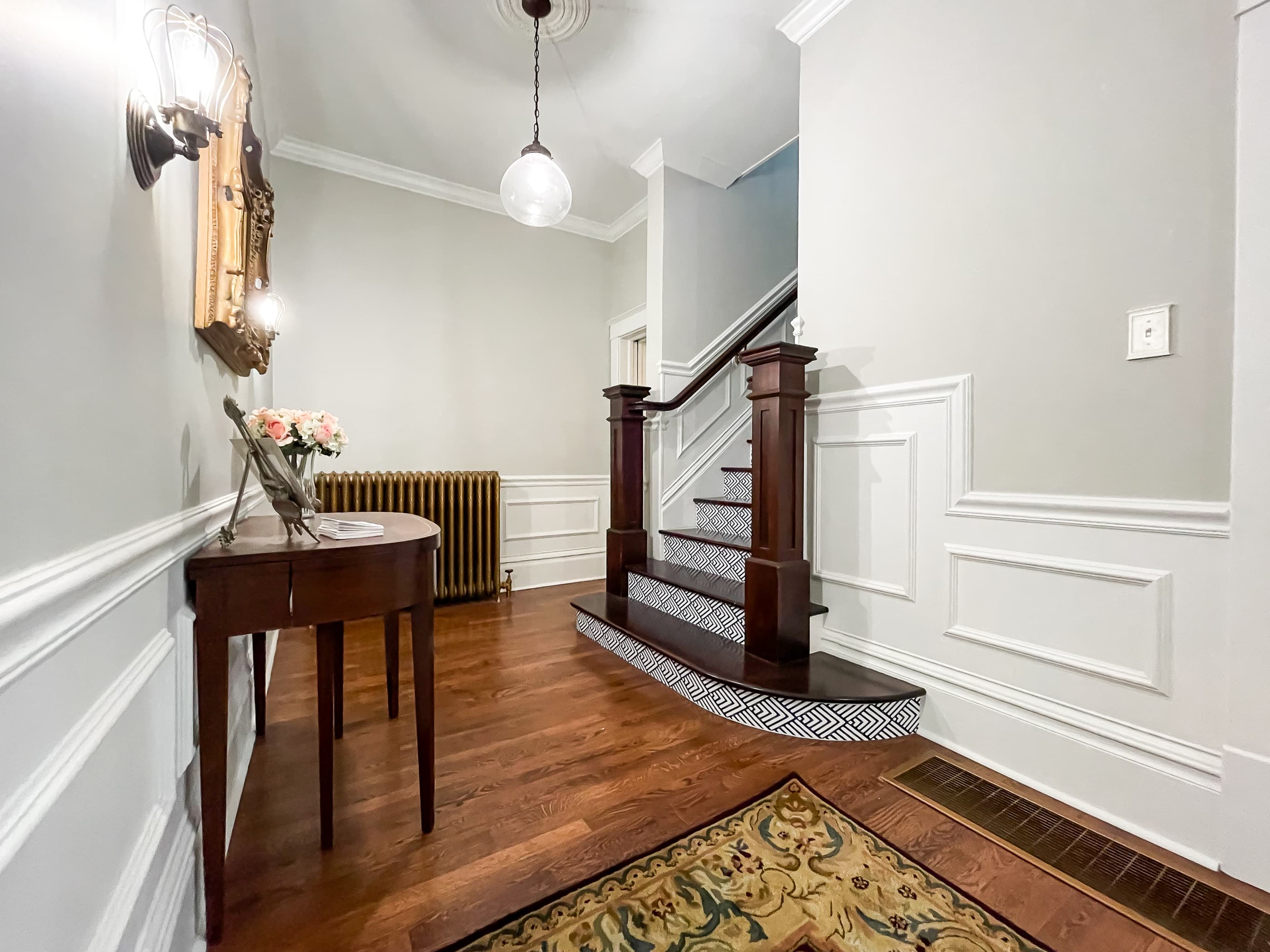 Mill Haus has a lovely grand entrance with glass globe lights and a grand front staircase that welcomes you to this century old home.