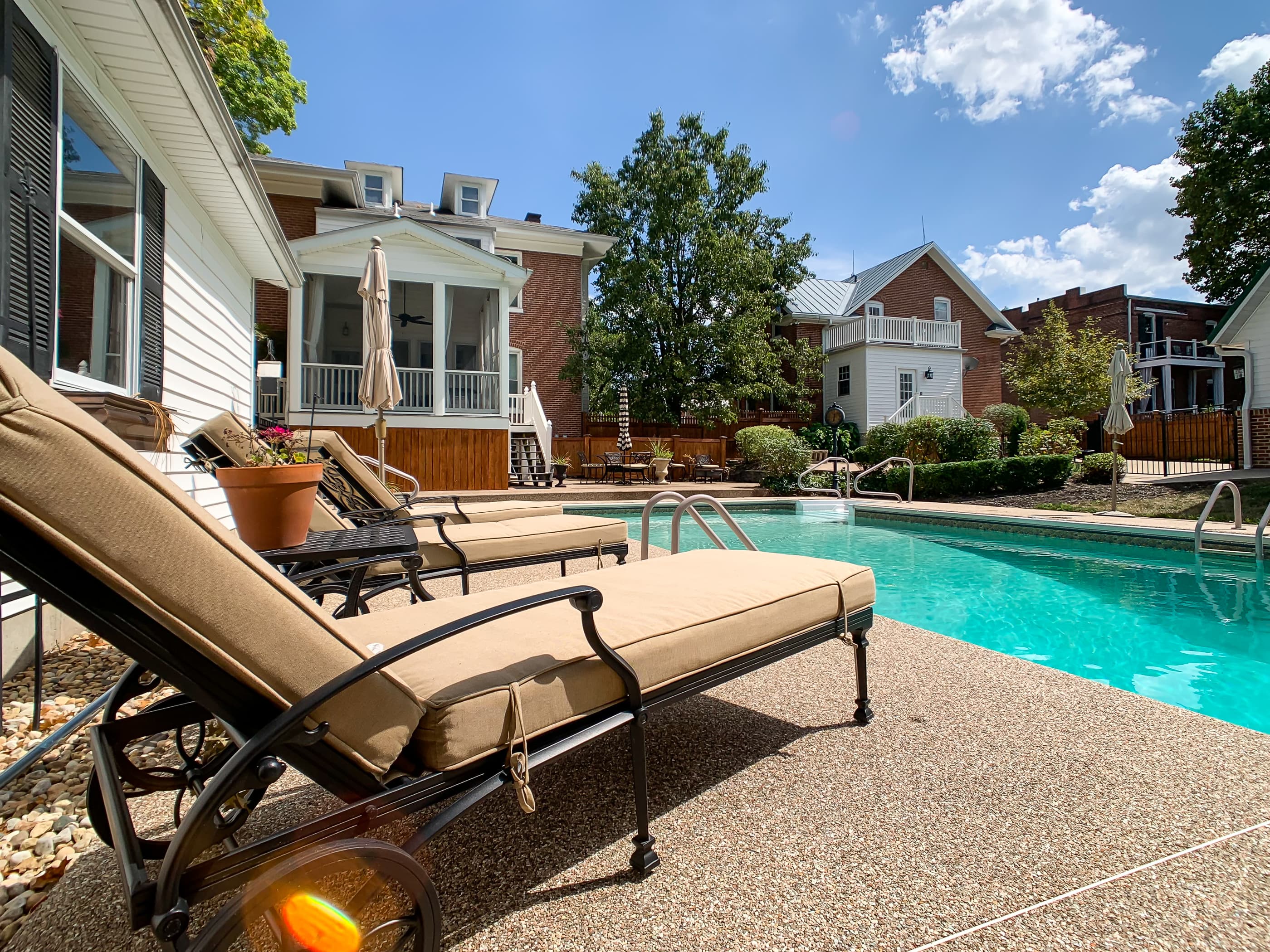 Mill Haus features a large backyard pool with plenty of lounge chairs to soak up the sun that is shared with the Beekeeper's Cottage.