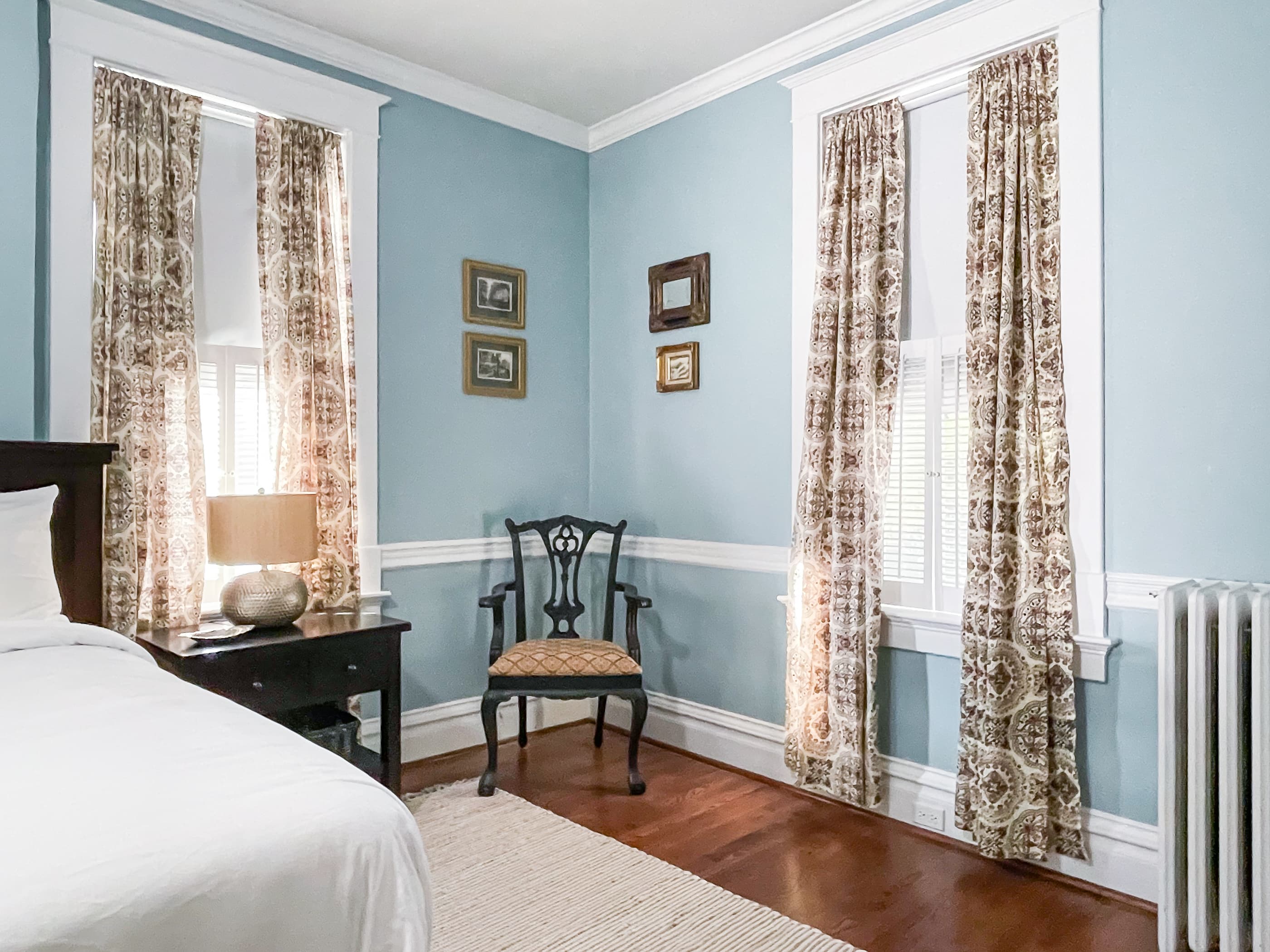 Mill Haus spacious blue bedroom has with a King bed with tons of natural light with en suite full bathroom on the second floor.

