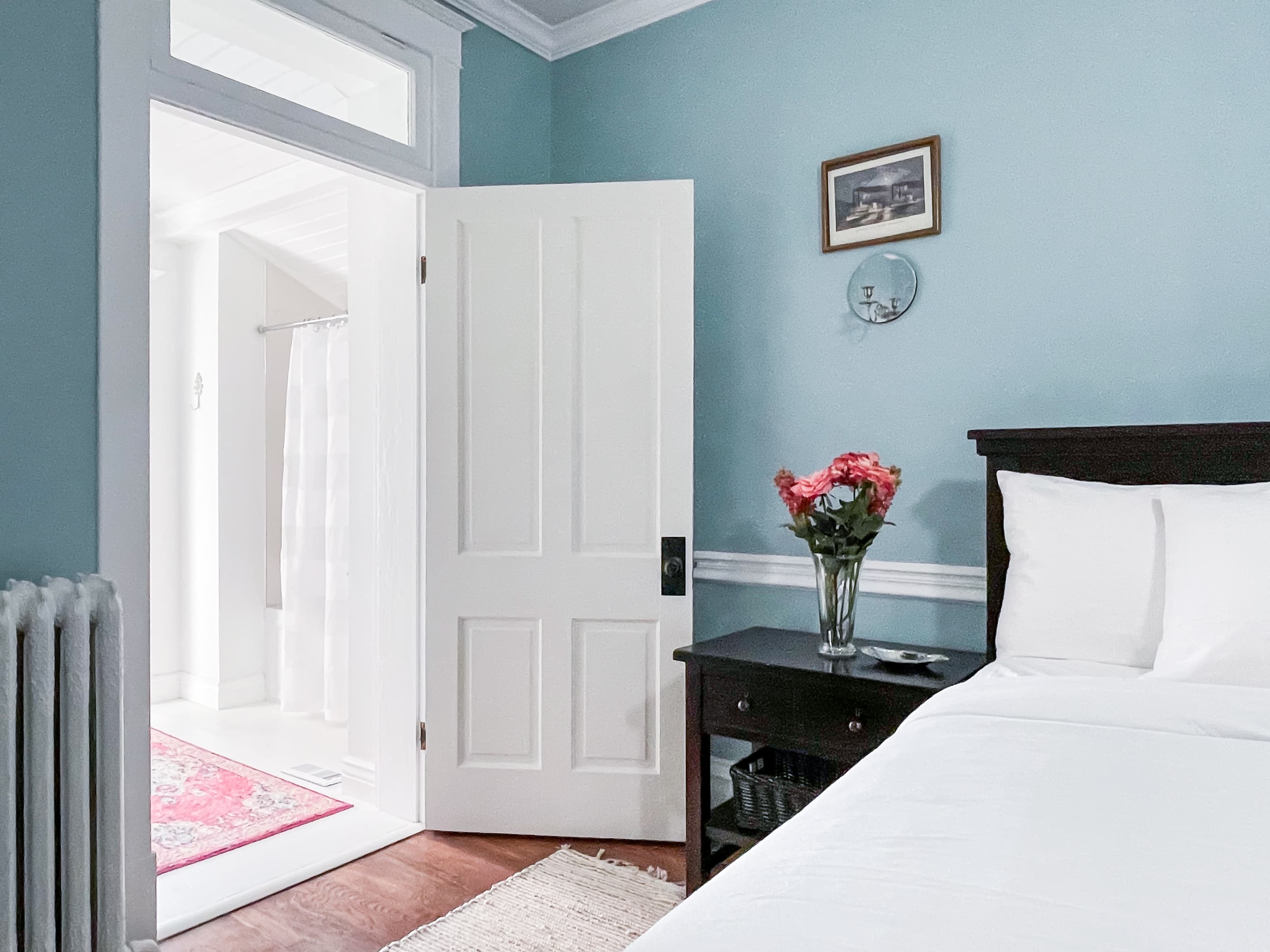 Mill Haus spacious blue bedroom has with a King bed with tons of natural light with en suite full bathroom on the second floor.
