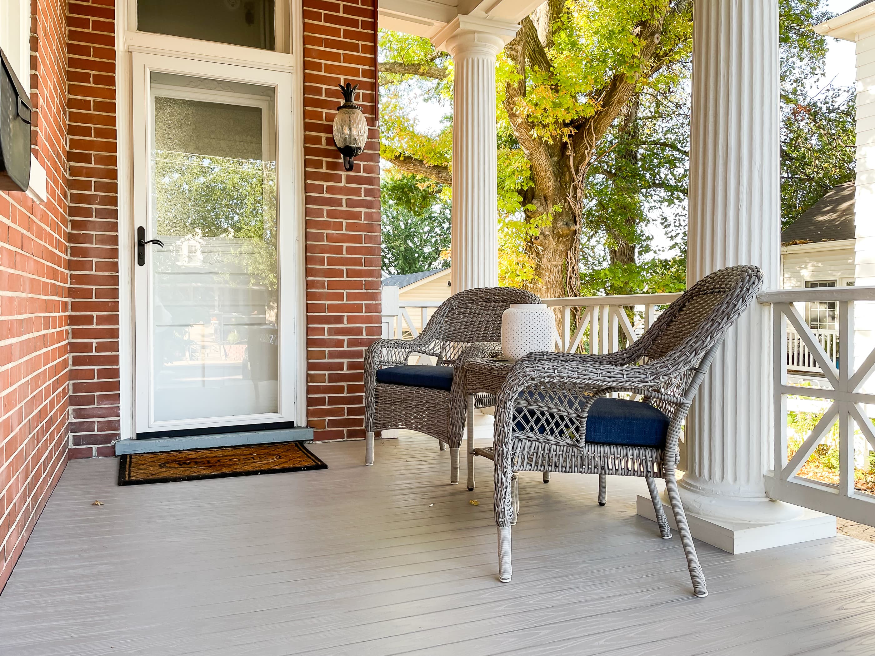 Mill Haus main entrance for guests is the side entrance.  It has 2 chairs and a table to enjoy morning coffee and you can watch the world go by on a century old porch.