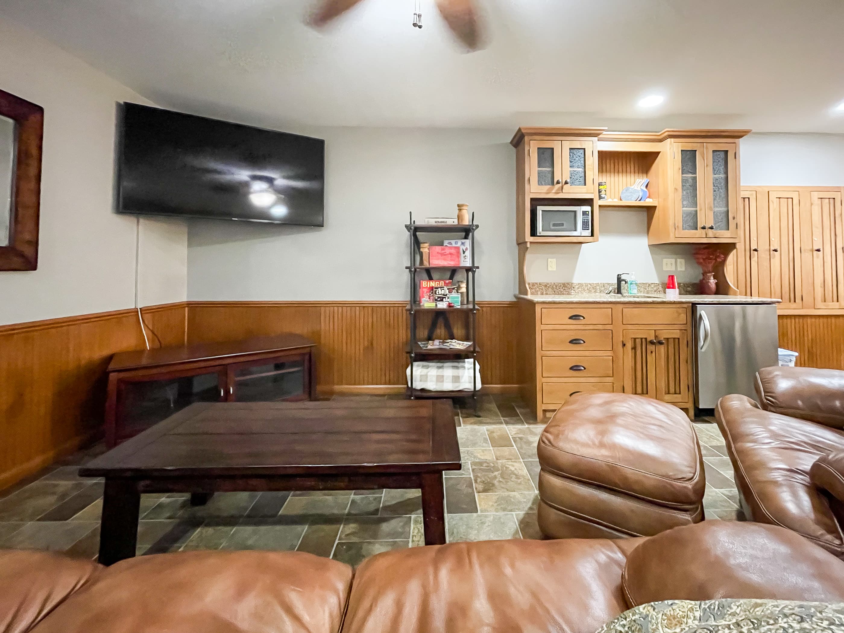OPTIONAL ADD ON: Spacious game room above the garage that includes a smart TV, games and comfy leather furniture for family/friend movie or game night.
