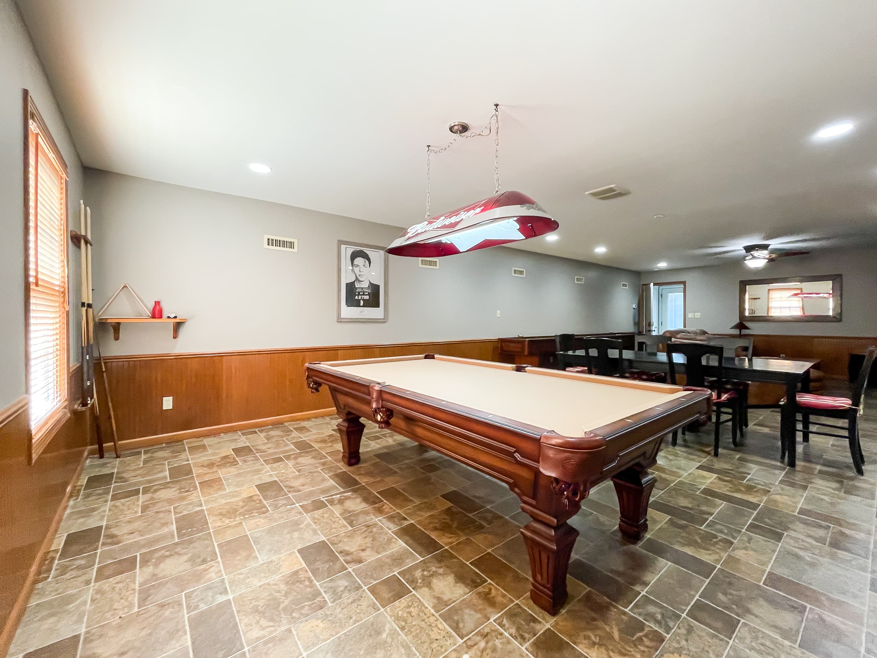 OPTIONAL ADD ON: Spacious game room above the garage that includes a pool table and dining room table and chairs for family game nights.
