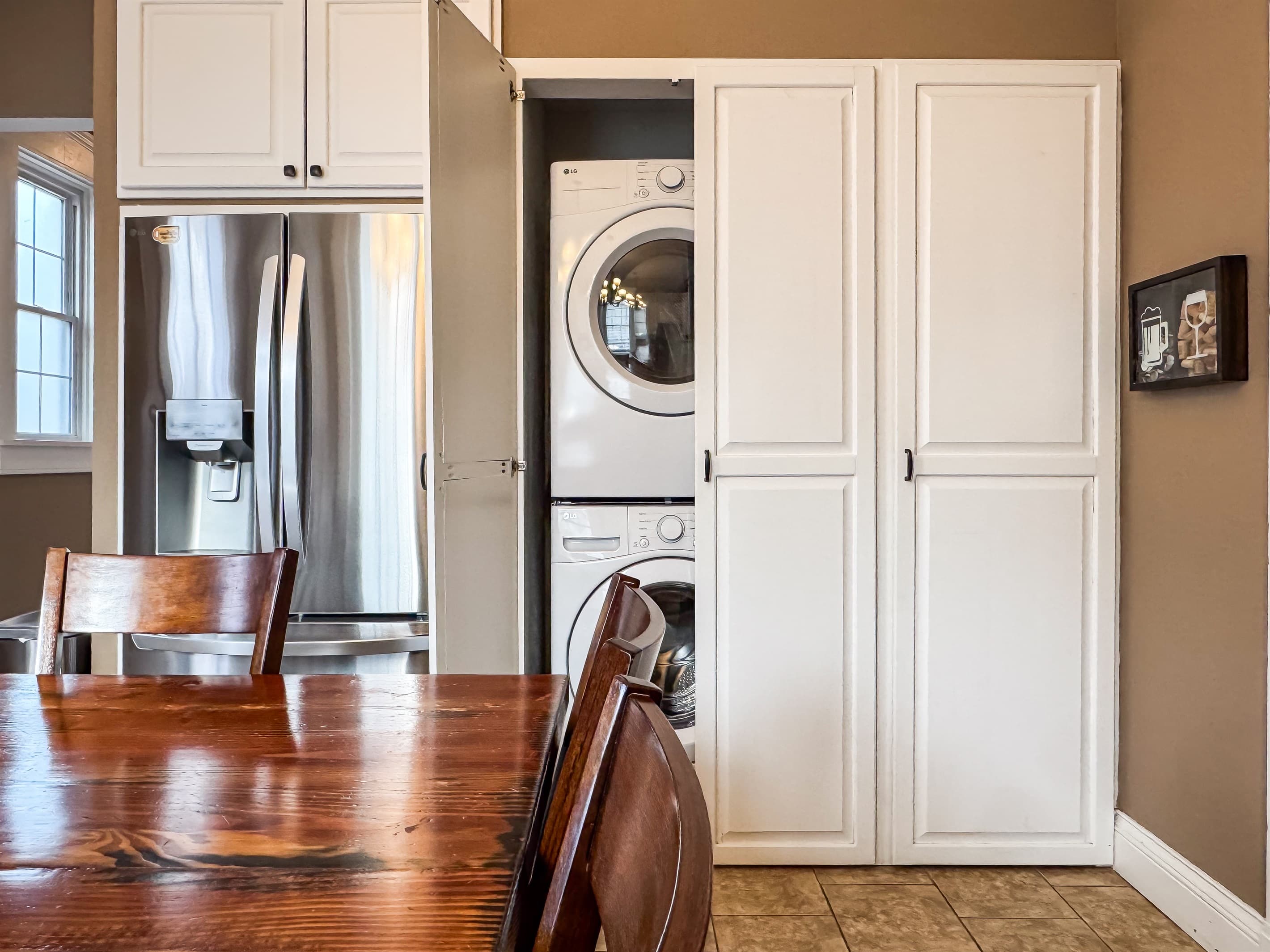 The spacious kitchen has all new appliances at Aussie Cottage.  The stacked full size washer and dryer are also on the main level behind the built in kitchen cabinets.