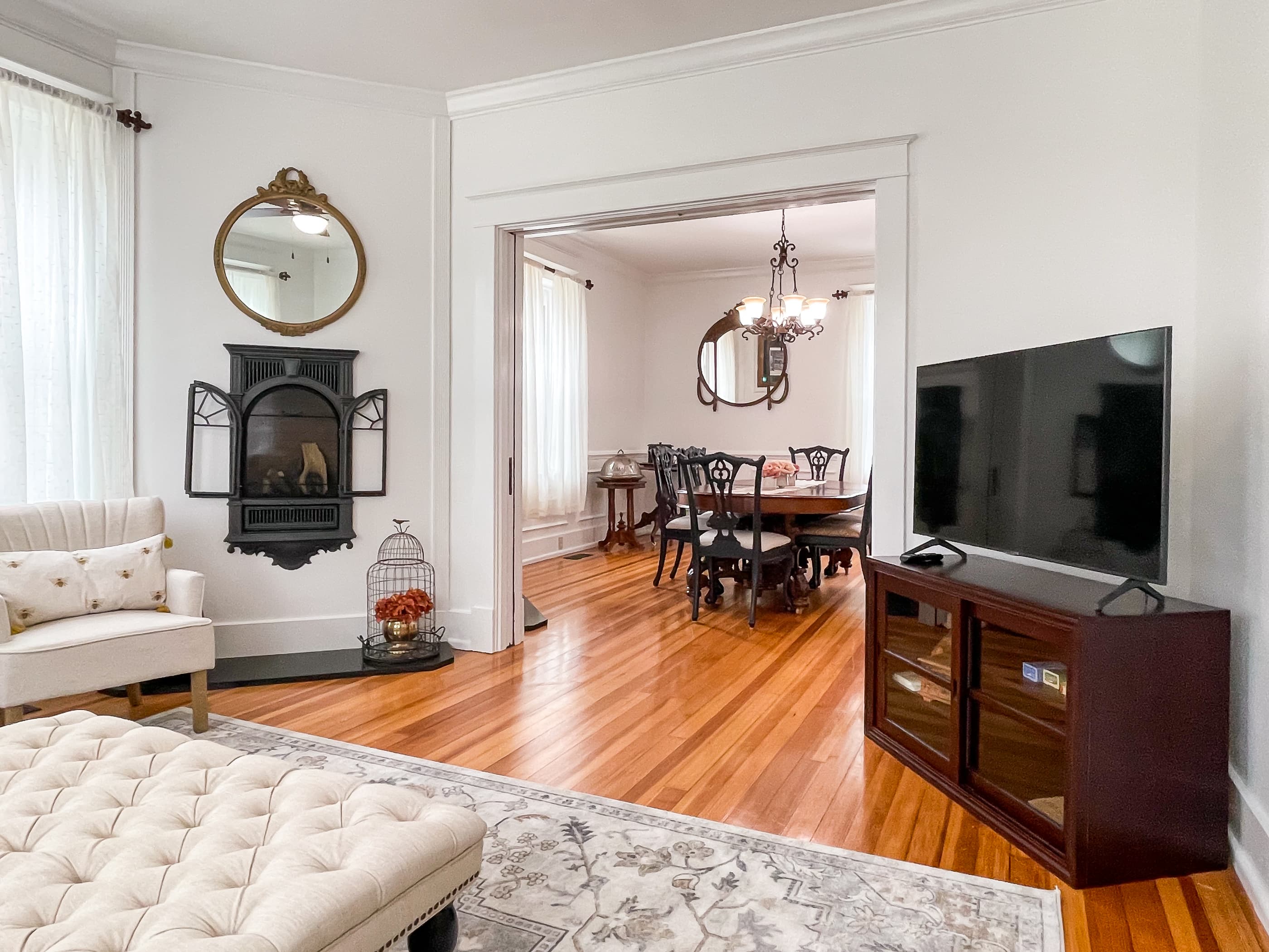 The Beekeeper's Cottage living area on the main level is an open spacious floor plan showcasing the fireplace, hardwood floors and flat screen smart TV for family movie night.