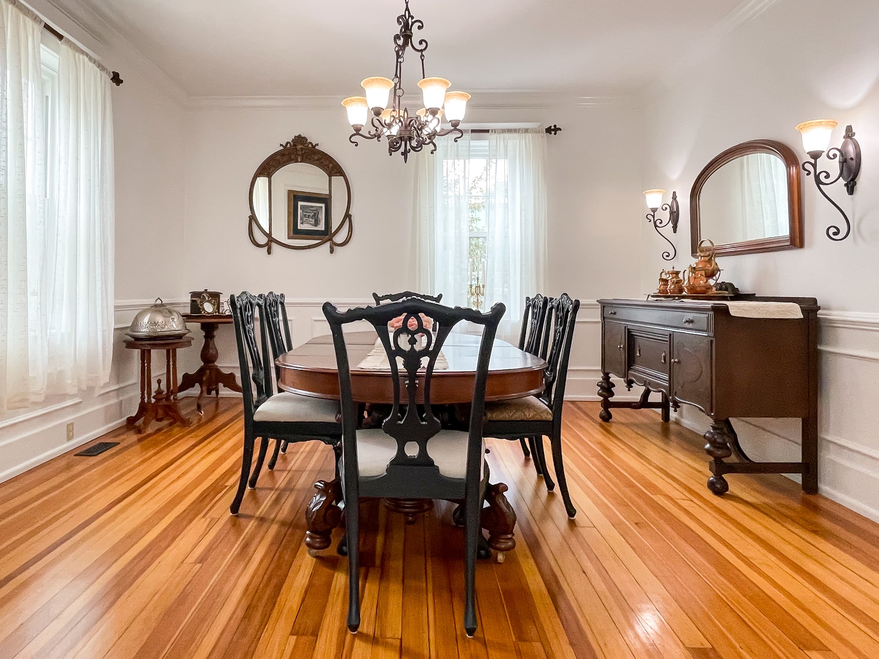 The large dining area includes a gorgeous hardwood dining table and seating for 6 people for family dinners or game night at The Beekeeper's Cottage.