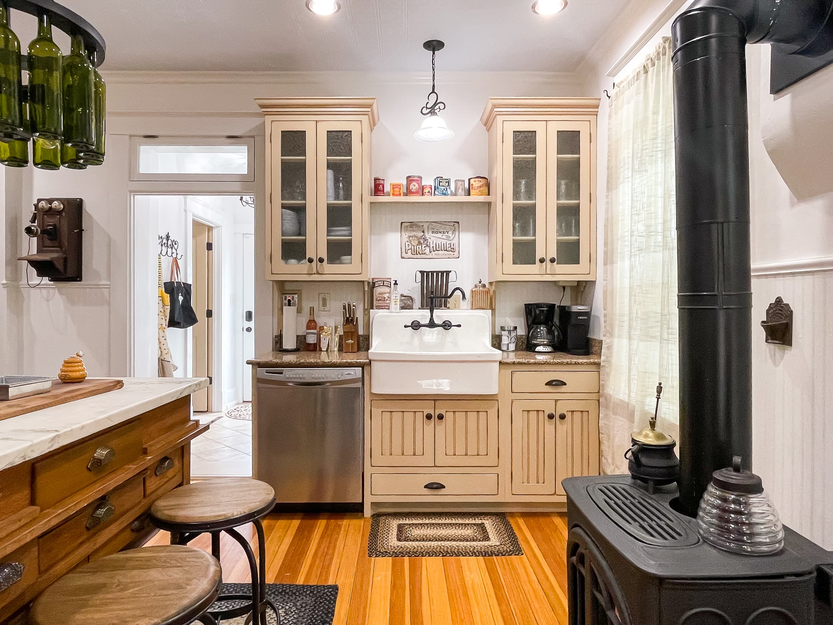 The beautifully detailed full kitchen has everything you need to make your own meals, including place settings, pots and pans, wine glasses, and a regular coffee maker or a Keurig at The Beekeeper's Cottage.