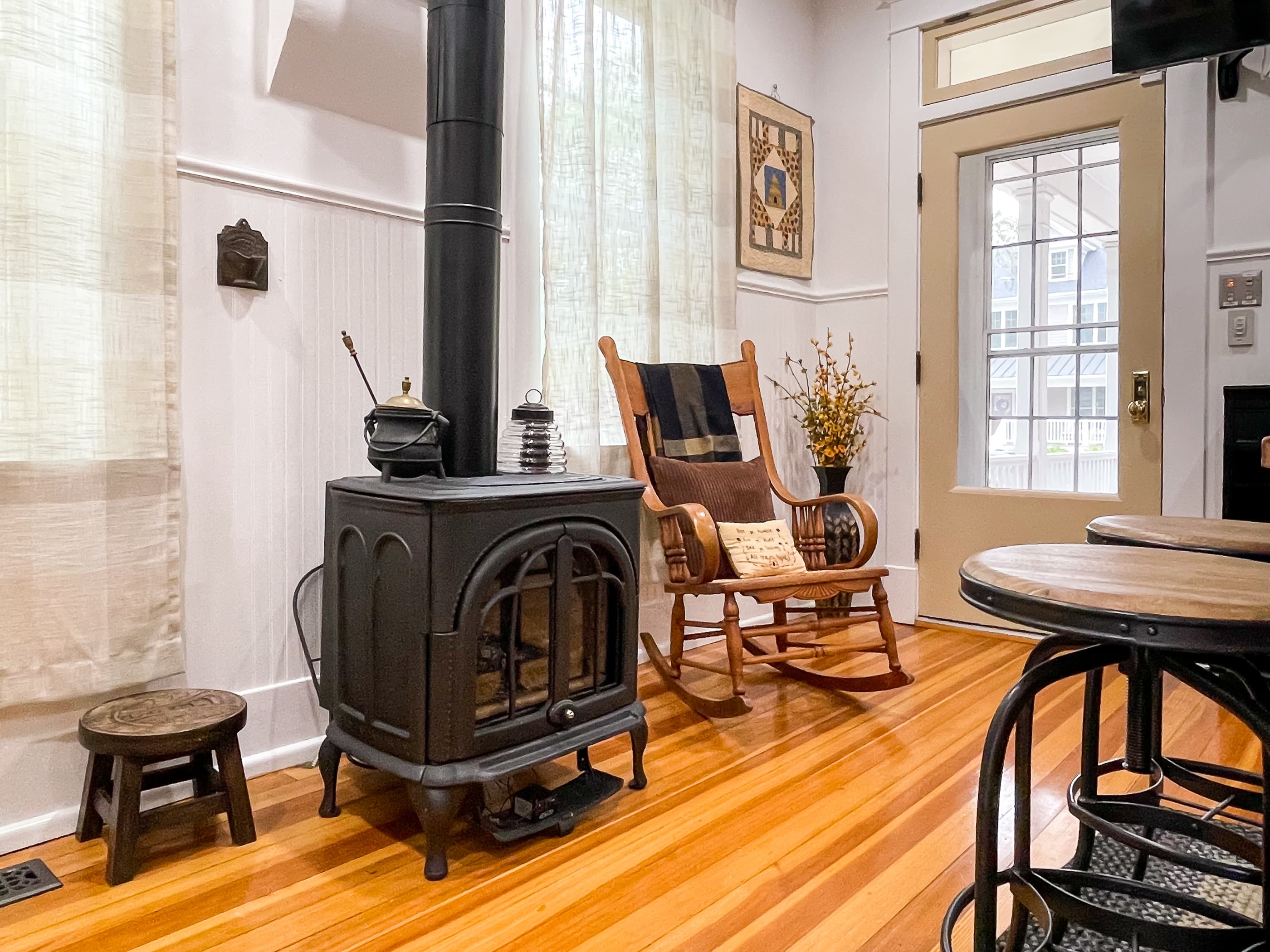The beautifully detailed full kitchen with modern amenities to enjoy prepping meals for your family/coworkers/friends and eclectic lighting made from wine bottles at The Beekeeper' Cottage.