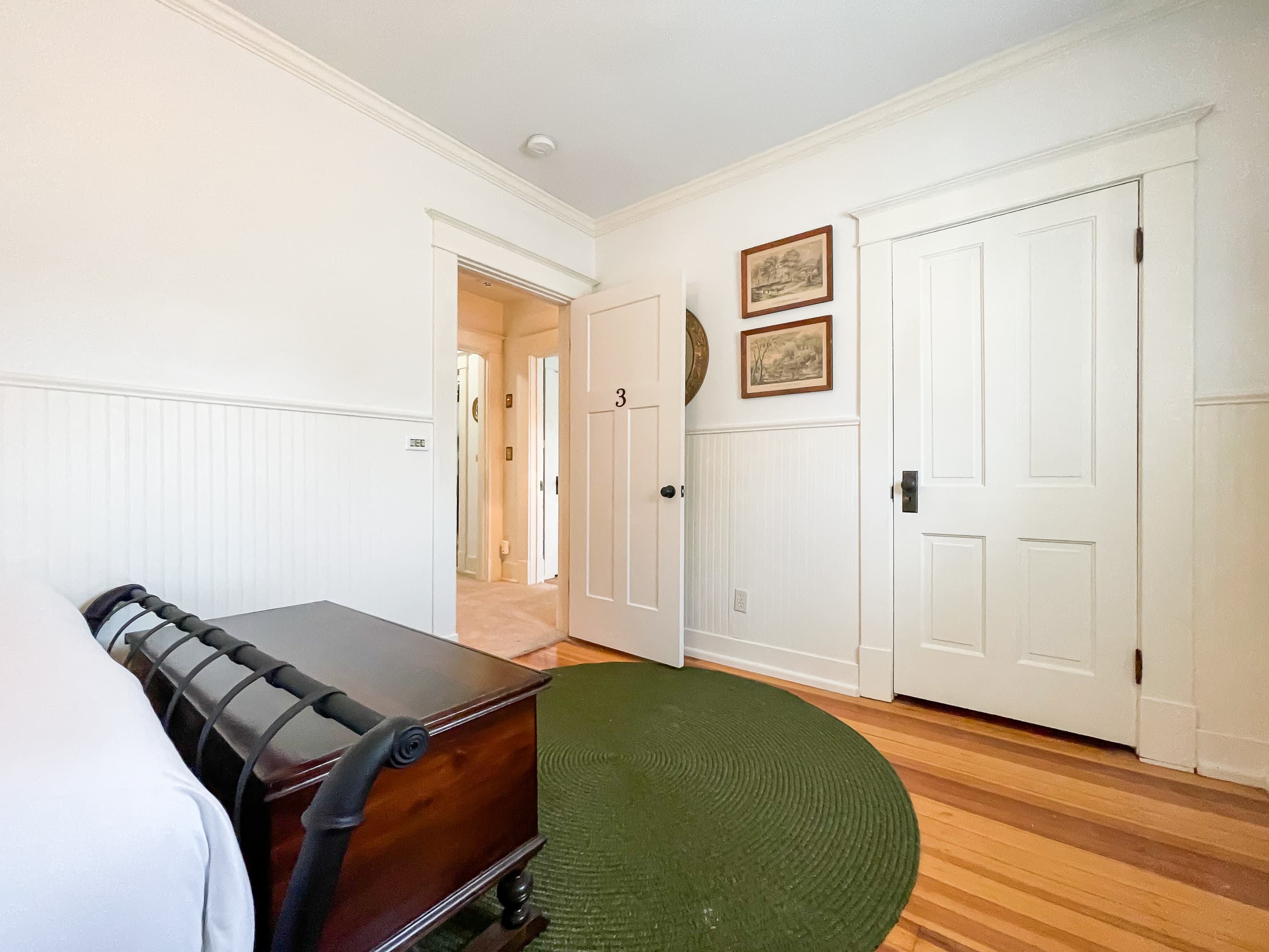 The cozy 3rd bedroom has a queen size bed with crisp white linens and share the second full bathroom with gorgeous clawfoot tub at The Beekeeper's Cottage.