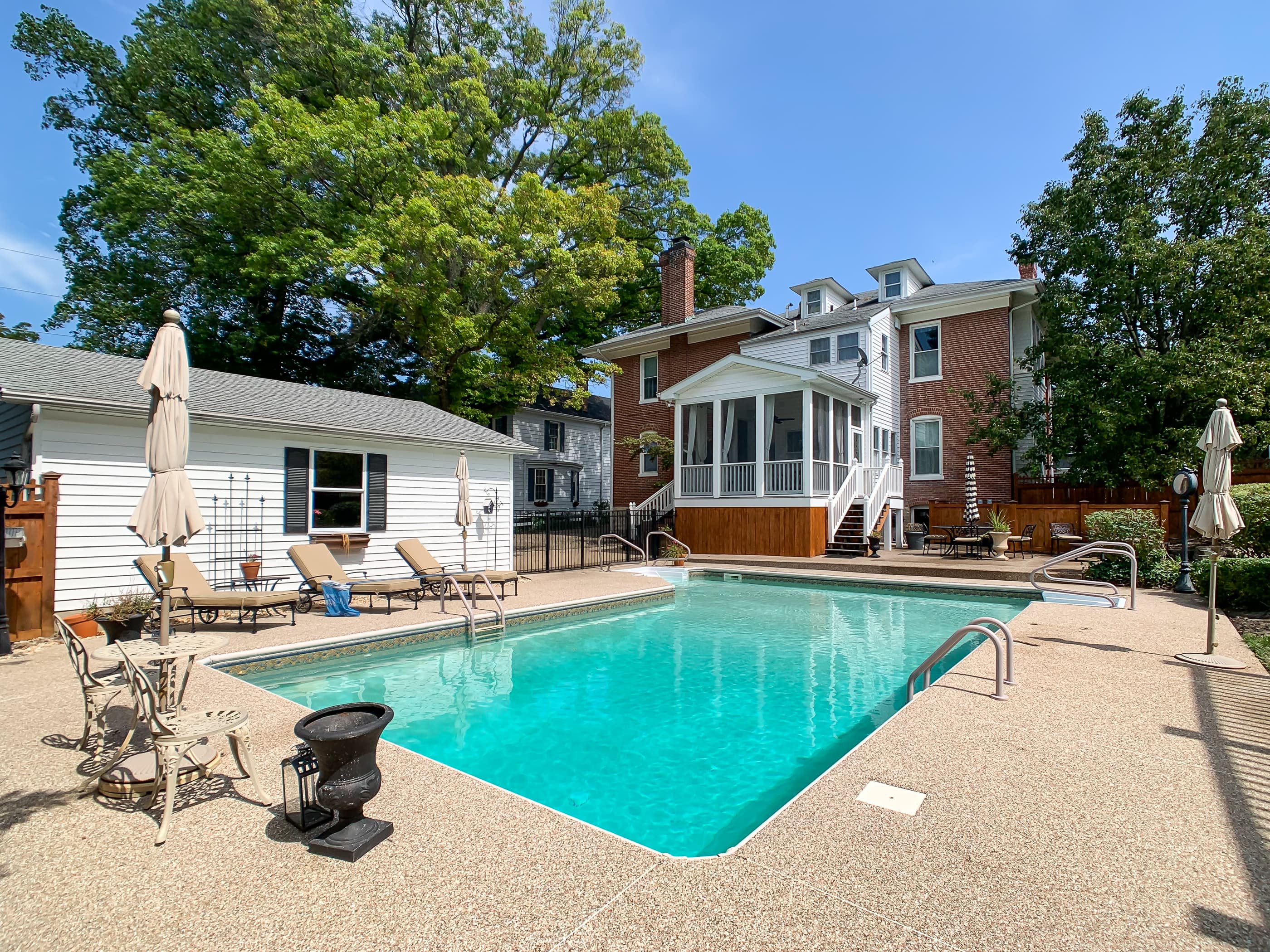 The fabulous Beekeeper's Cottage backyard!! This backyard and swimming pool is shared with the Mill Haus next door (shown in the photo) -- Pool is open approximately mid-April through October (depending on weather).