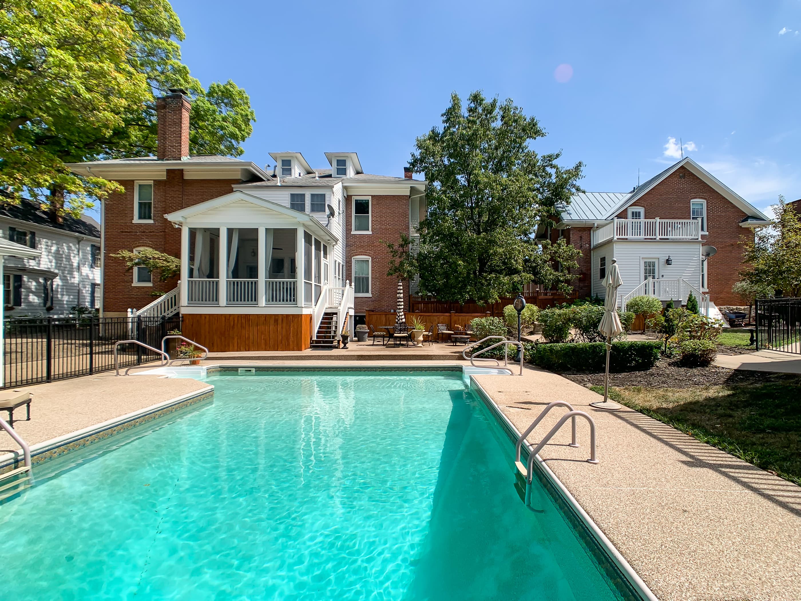The fabulous Beekeeper's Cottage backyard!! This backyard and swimming pool is shared with the Mill Haus next door (shown in the photo) -- Pool is open approximately mid-April through October (depending on weather).