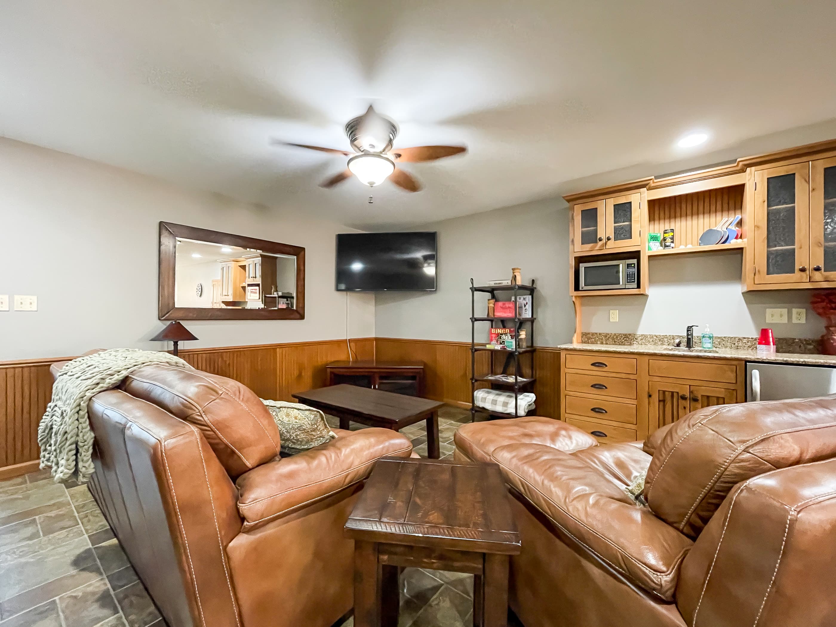 OPTIONAL ADD ON: Beekeepers Cottage Garage upper level game room with flat screen Smart TV and comfy leather furniture great for game or movie night with family and friends.