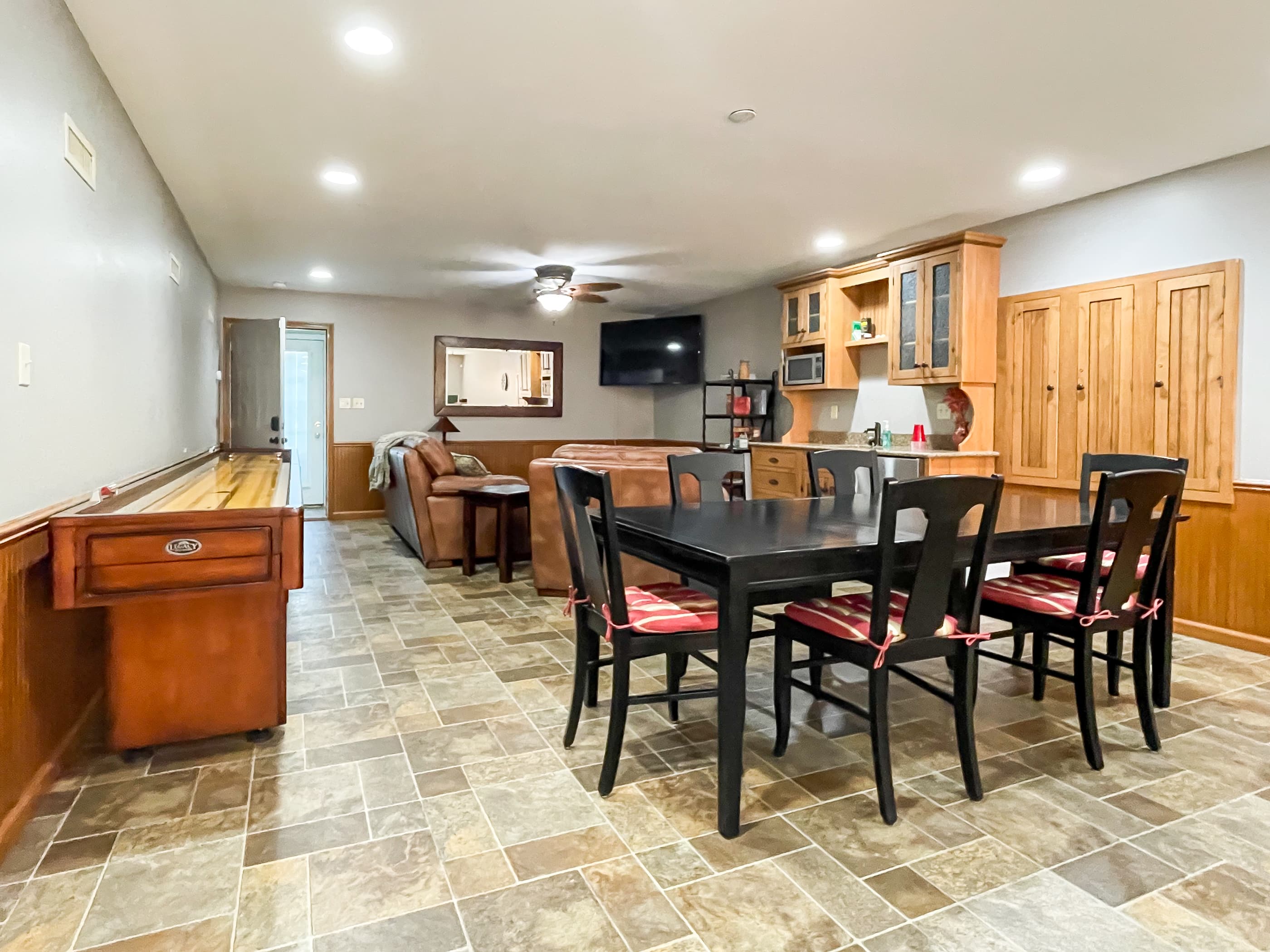 OPTIONAL ADD ON: Beekeepers Cottage Garage upper level game room with table and chairs, shuffle board, pool table, flat screen Smart TV and comfy leather furniture great for game or movie night with family and friends.