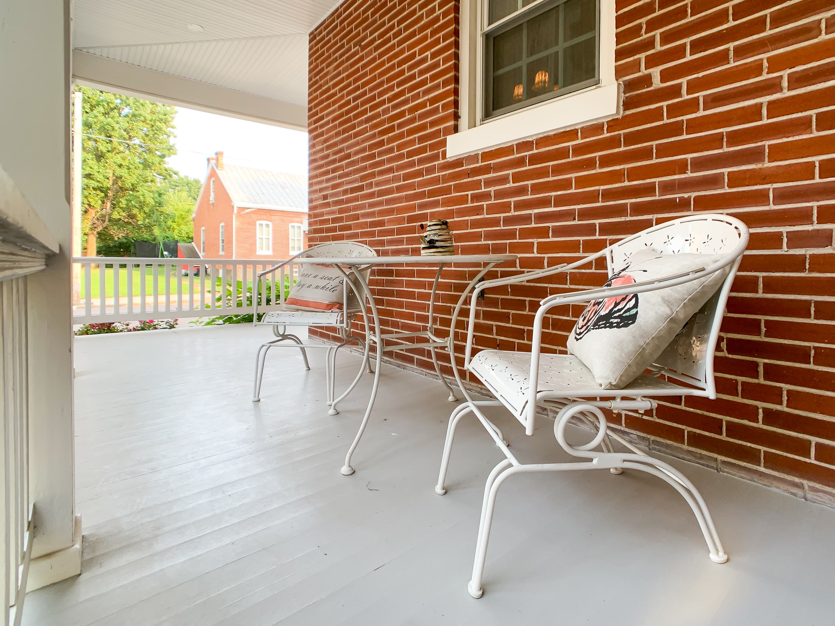 The historic Beekeeper's Cottage features a veranda style front porch that wraps around the side and provides additional open living space to enjoy the outdoors.