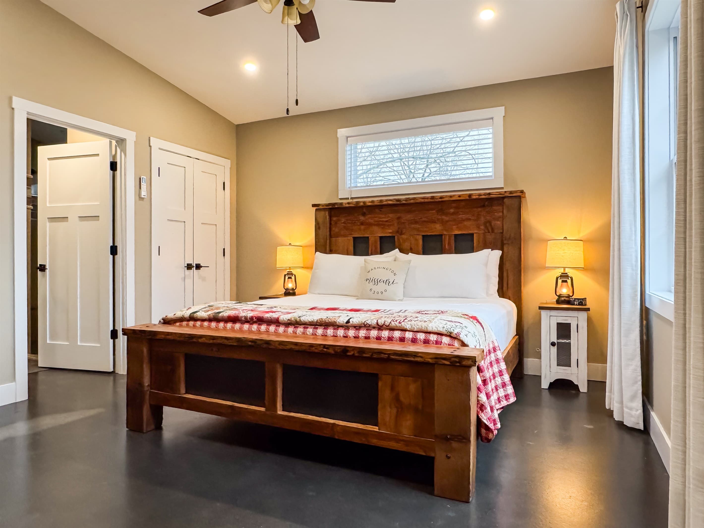 Open and inviting bedroom with king size bed and bathroom access.