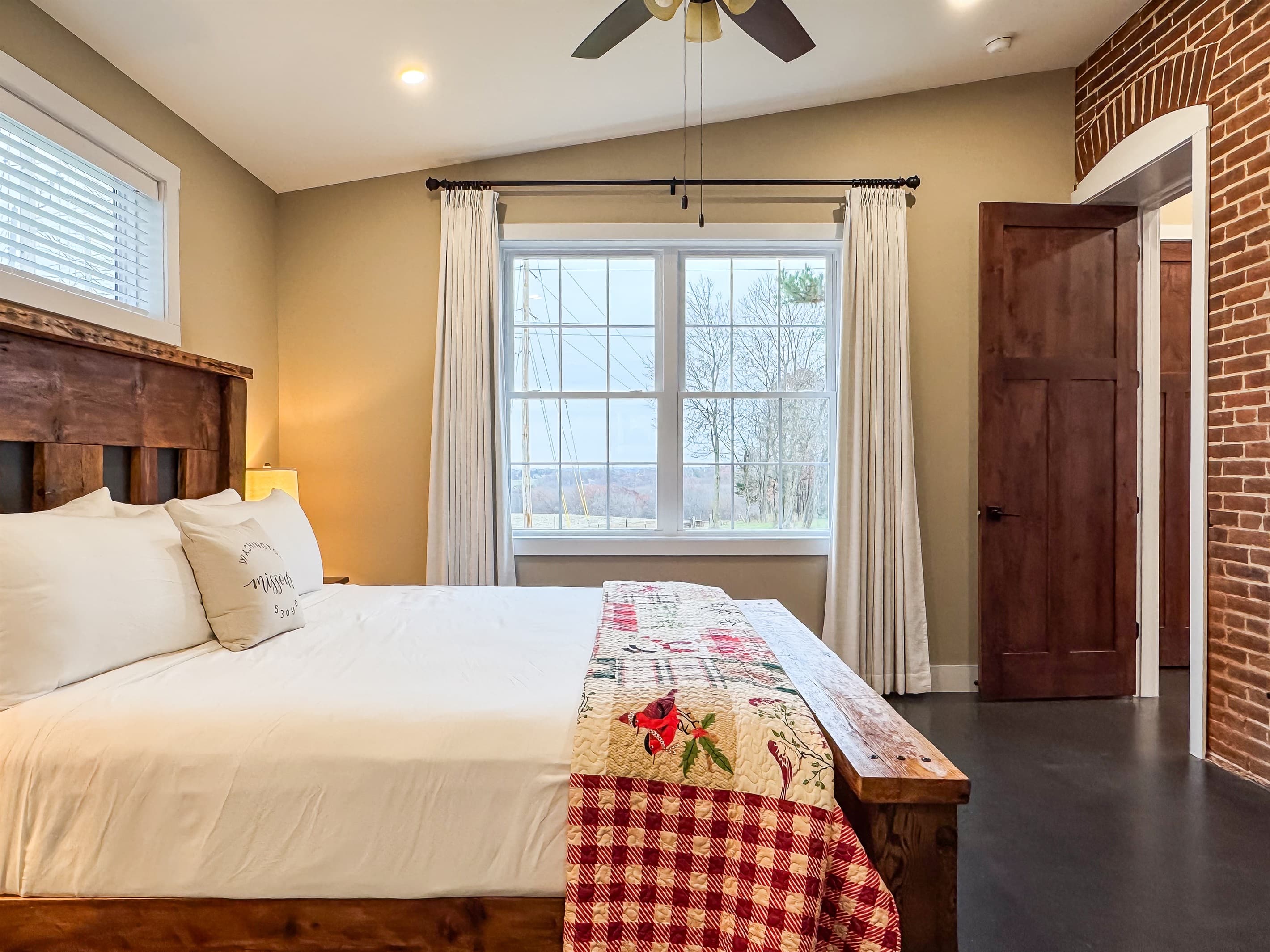 Natural light and views of the rolling hills await! The large bedroom offers ample space around all sides of the king bed.