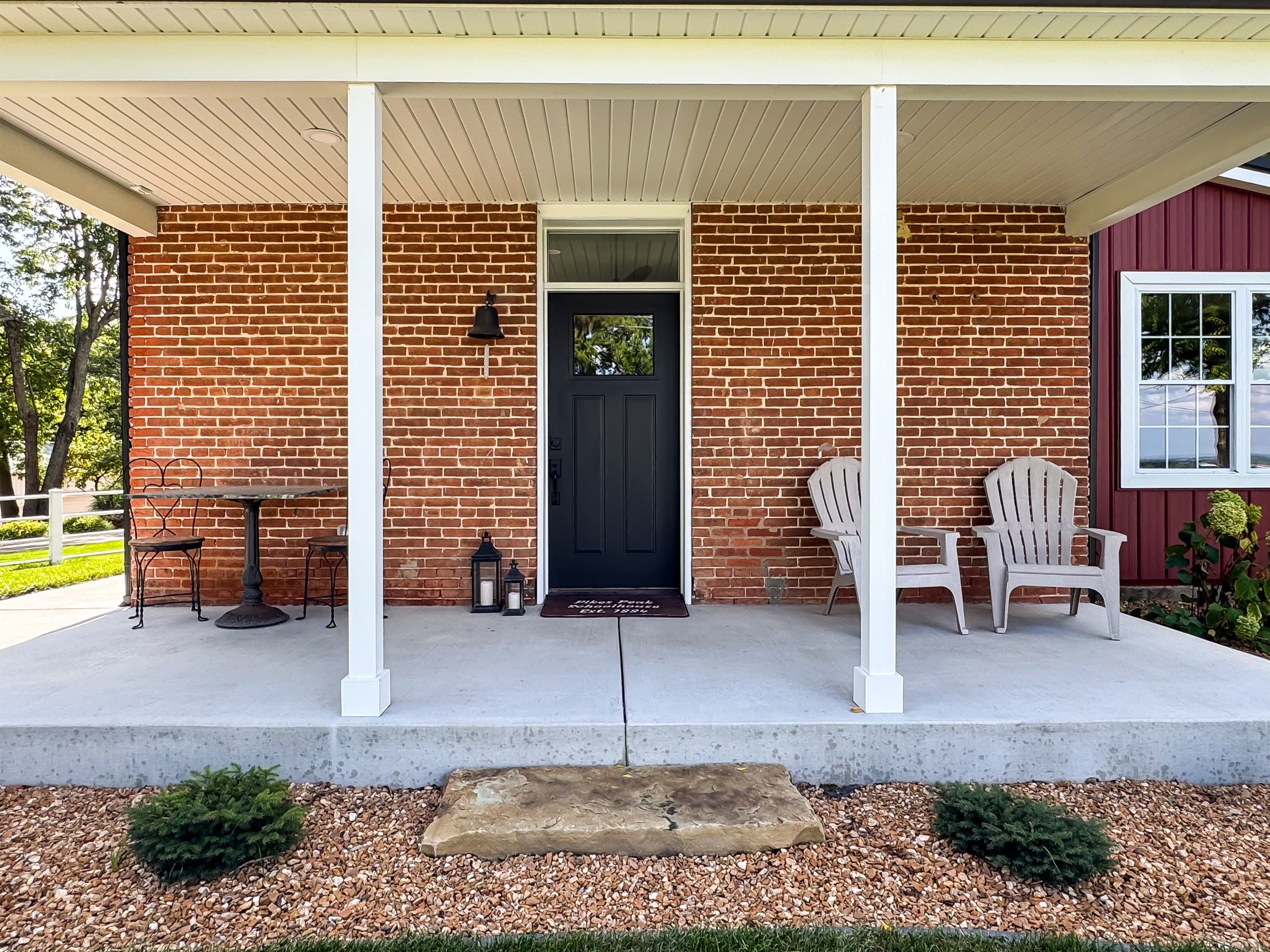 A fabulous front porch to enjoy your morning coffee to watch the sunrise at Pikes Peak Schoolhouse which is a vintage schoolhouse with all the modern comforts of home.