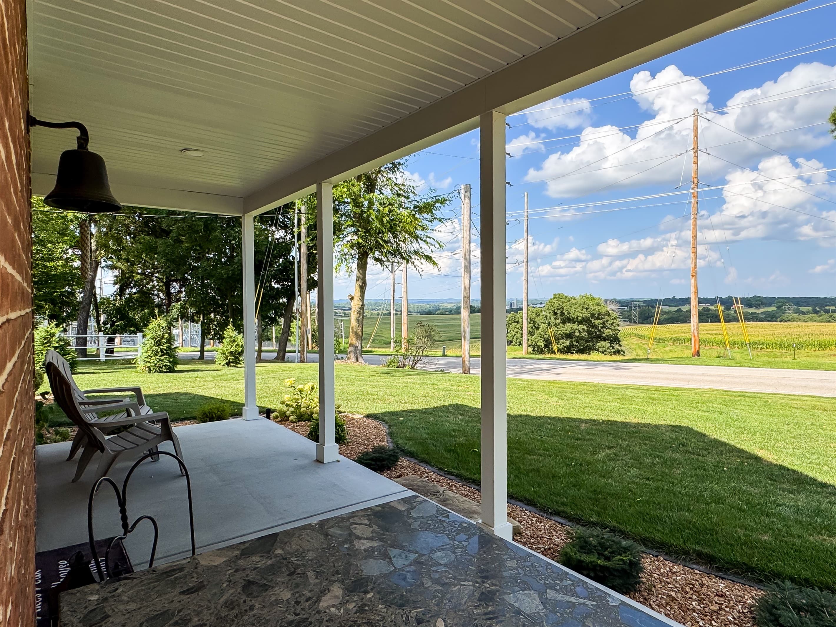 A fabulous front porch to enjoy your morning coffee with country side views at Pikes Peak Schoolhouse which is a vintage schoolhouse with all the modern comforts of home.
