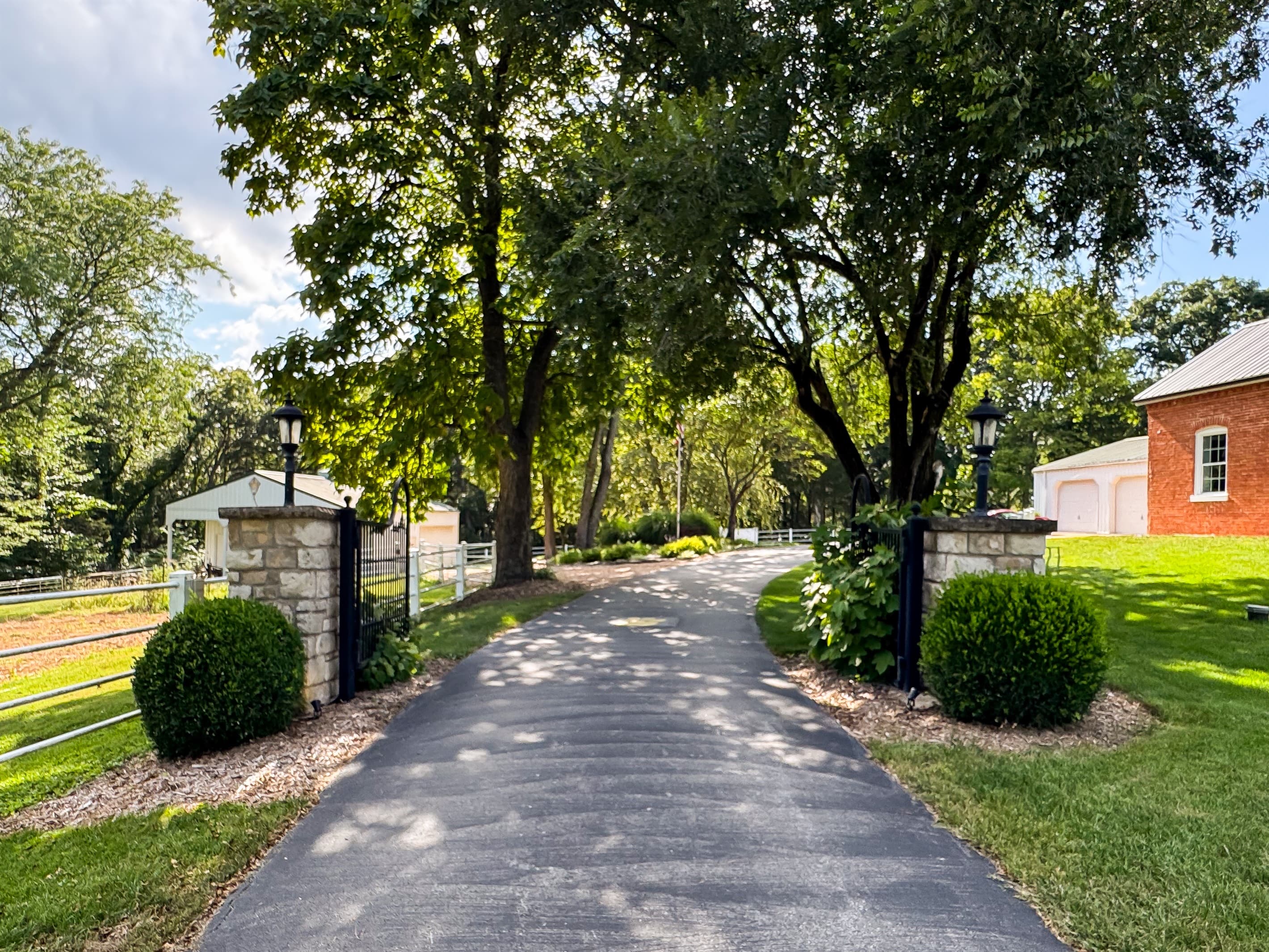 Entrance to the adorable Pikes Peak Schoolhouse with paved driveway and big trees as you enter the property that is between Union and Washington, close to Purina Farms, wineries and an hour away from downtown St. Louis baseball stadium with country views.