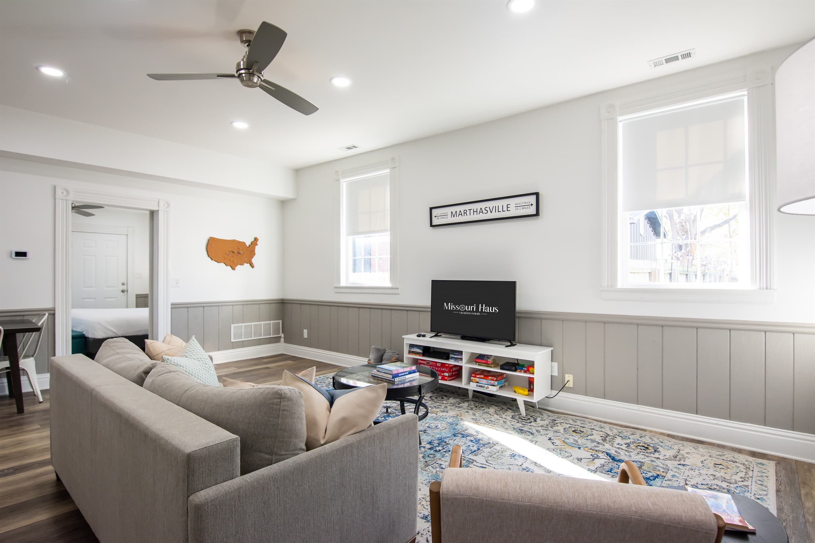 Spacious living area with smart TV, king pull out couch, and ample seating at the Katy Haus.