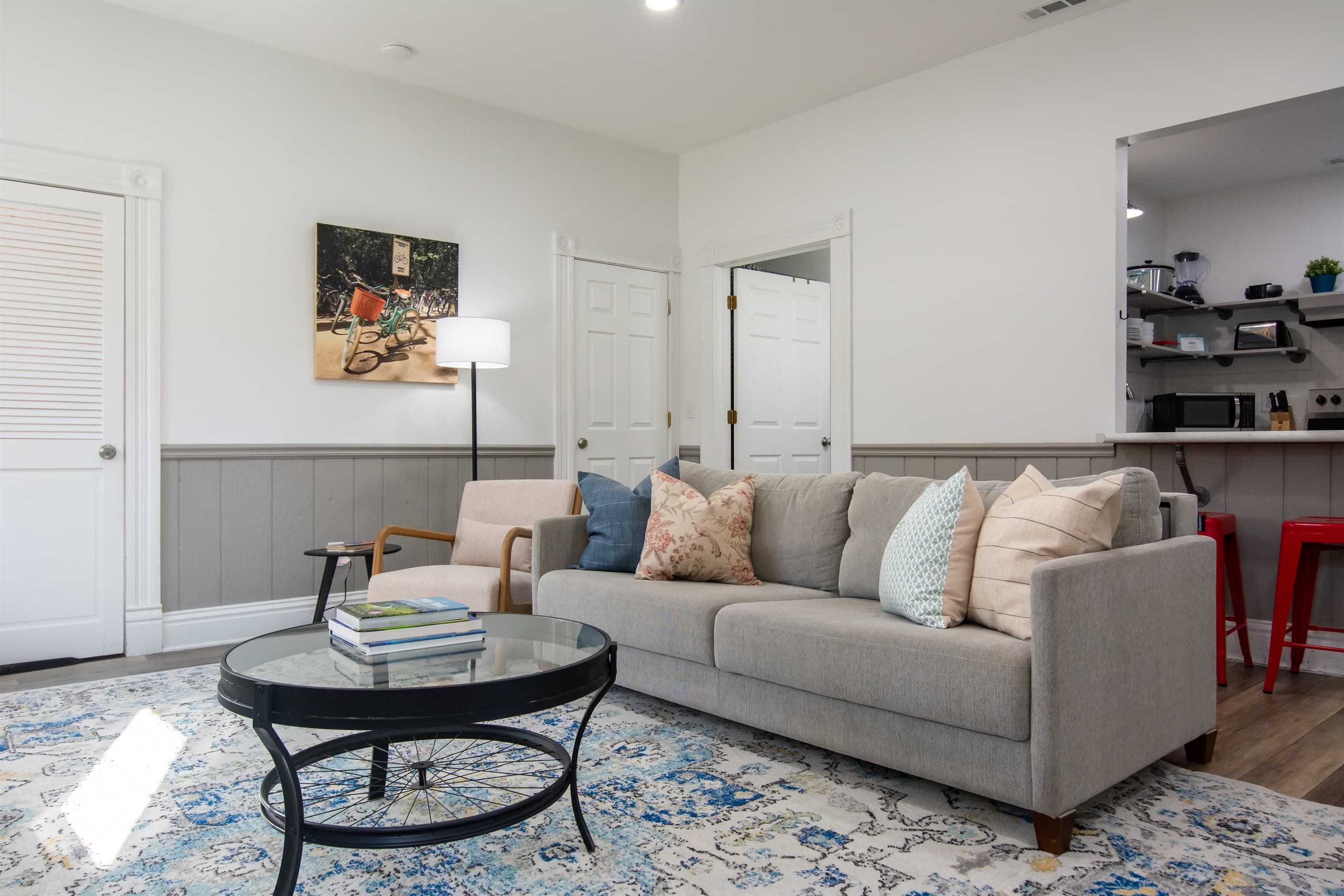 Spacious living area with king size pull out bed, comfy chair, and and abundance of natural light at the Katy Haus.