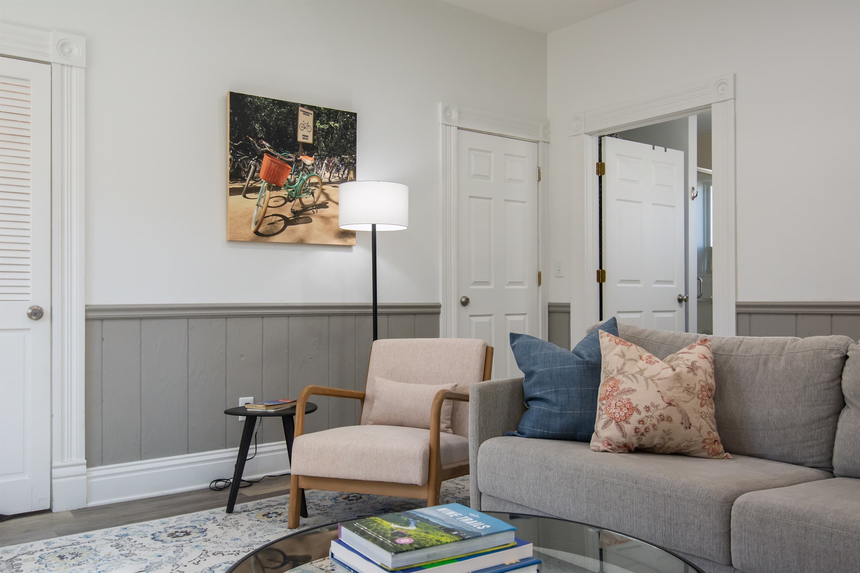 Spacious living area with king size pull out bed, comfy chair, and and abundance of natural light at the Katy Haus.