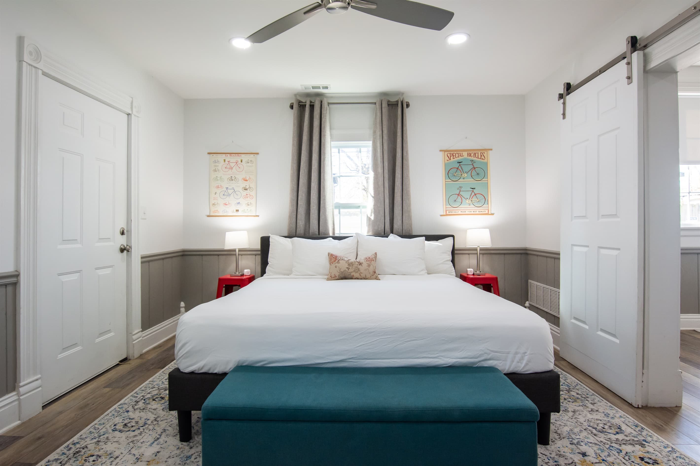 Cozy king bed with side tables, charging blocks, and door to access front porch.