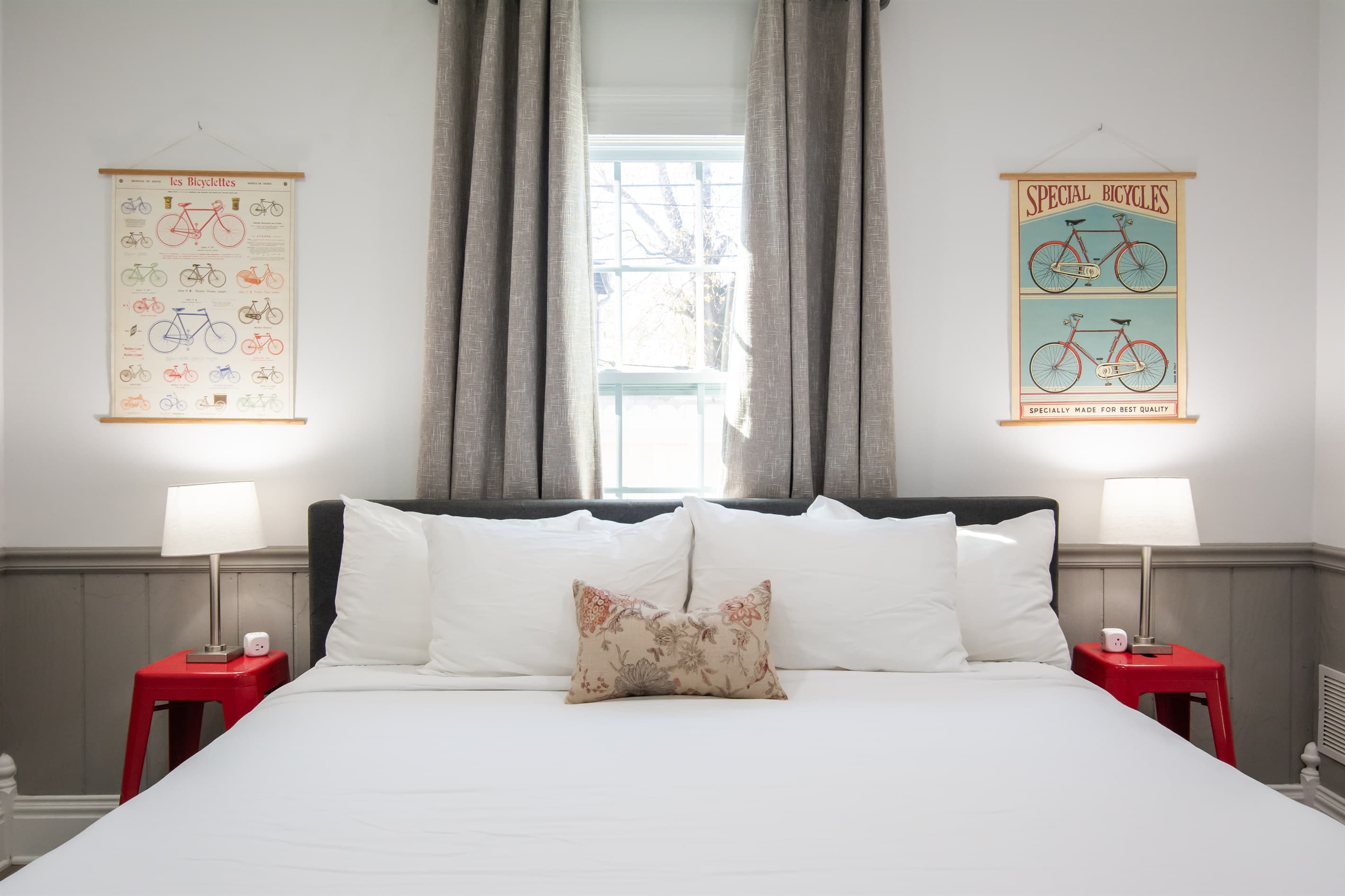 Cozy king bed with side tables, charging blocks, and side lamps.