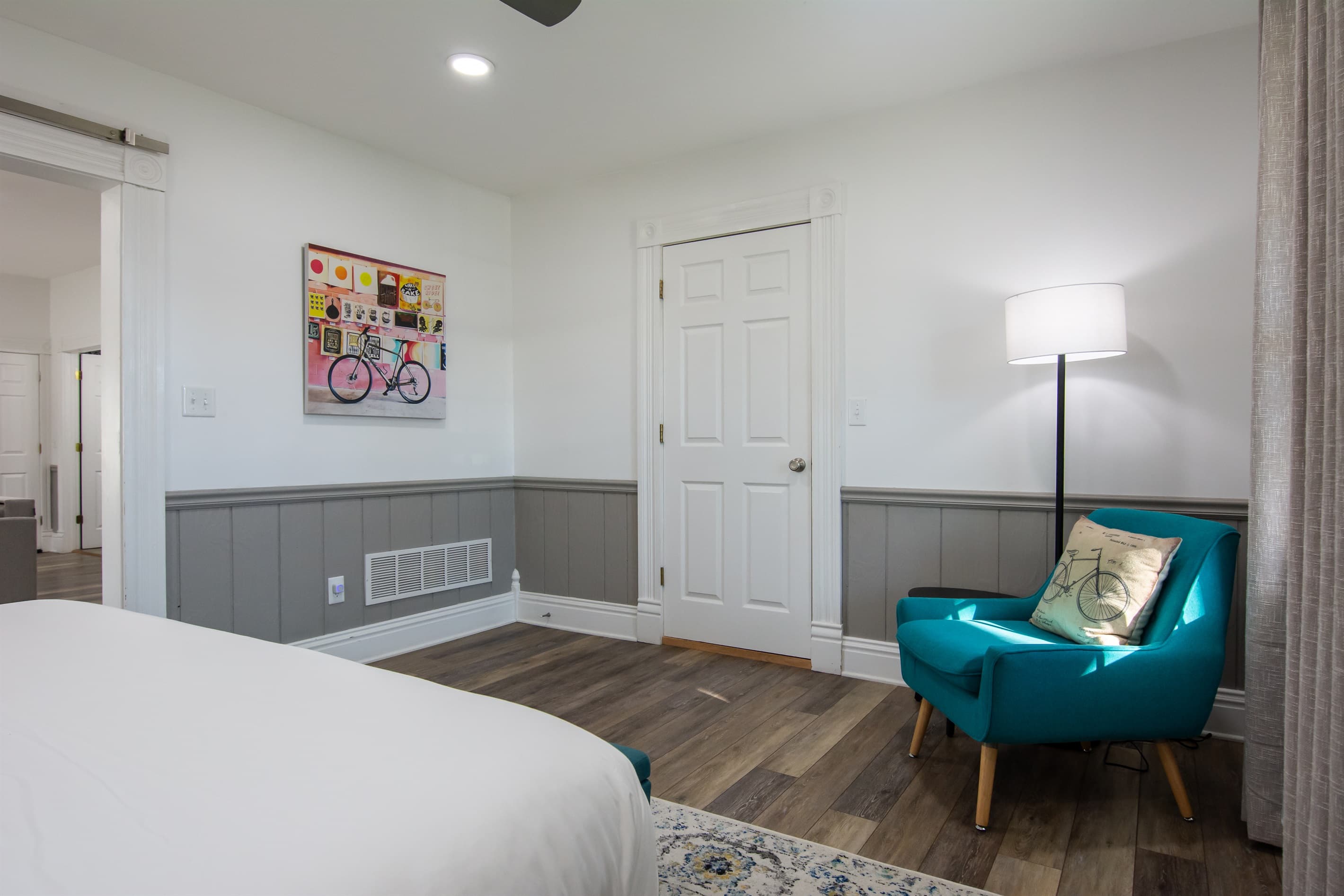 Extra seating in bedroom with side table at the Katy Haus.
