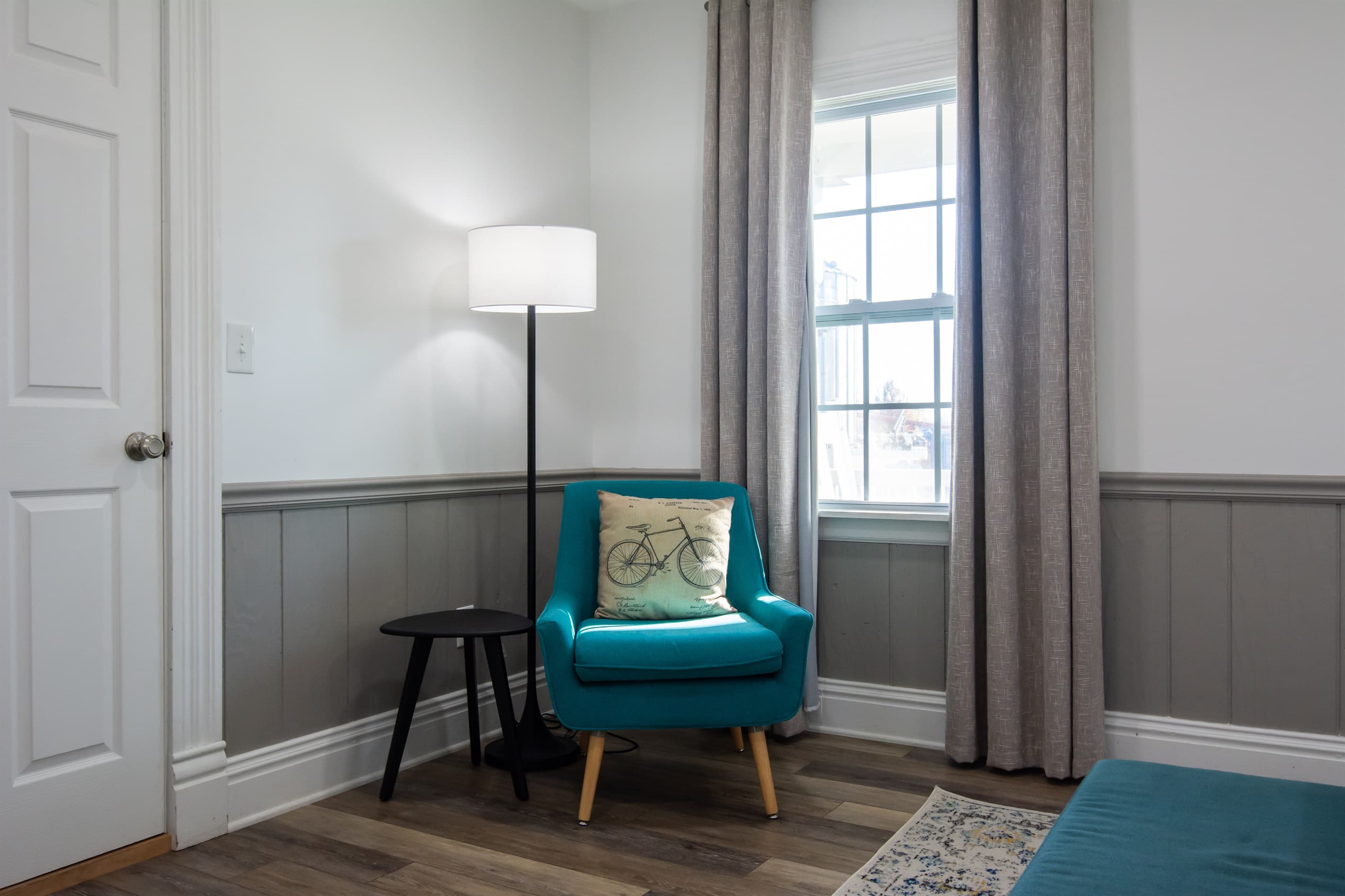 Extra seating in bedroom with side table at the Katy Haus.